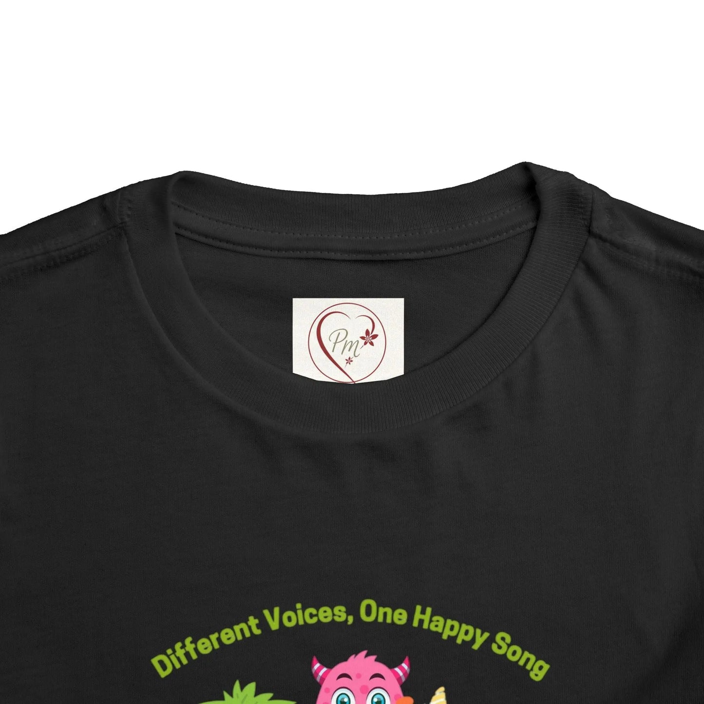 Black t-shirt with 'Different Voices, One Happy Song' text and PM Creations 25 logo on a Black background