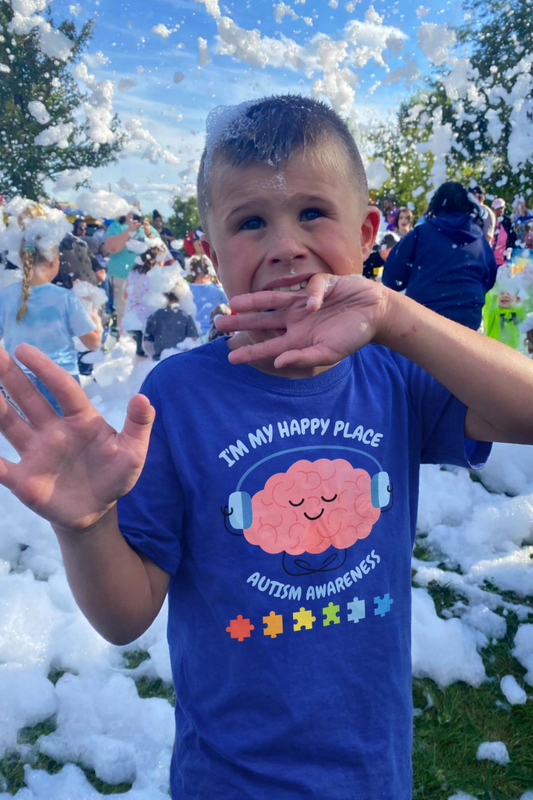 Child wearing an autism awareness shirt from PM Creations 25
