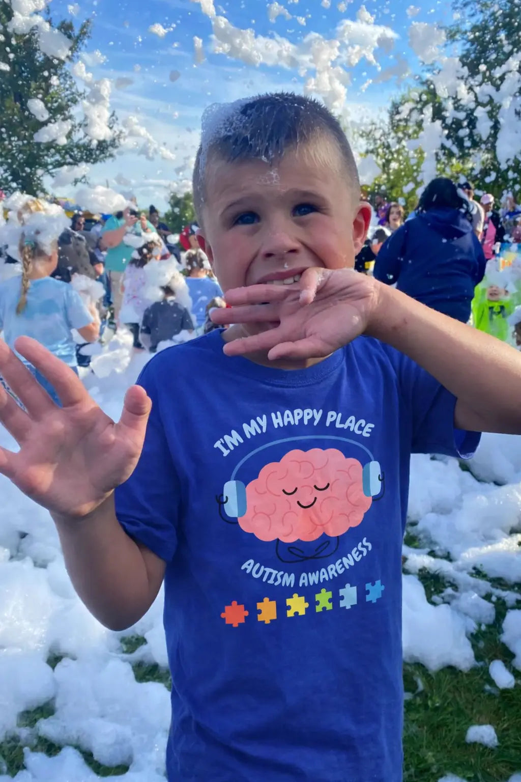 Child wearing an autism awareness shirt from PM Creations 25
