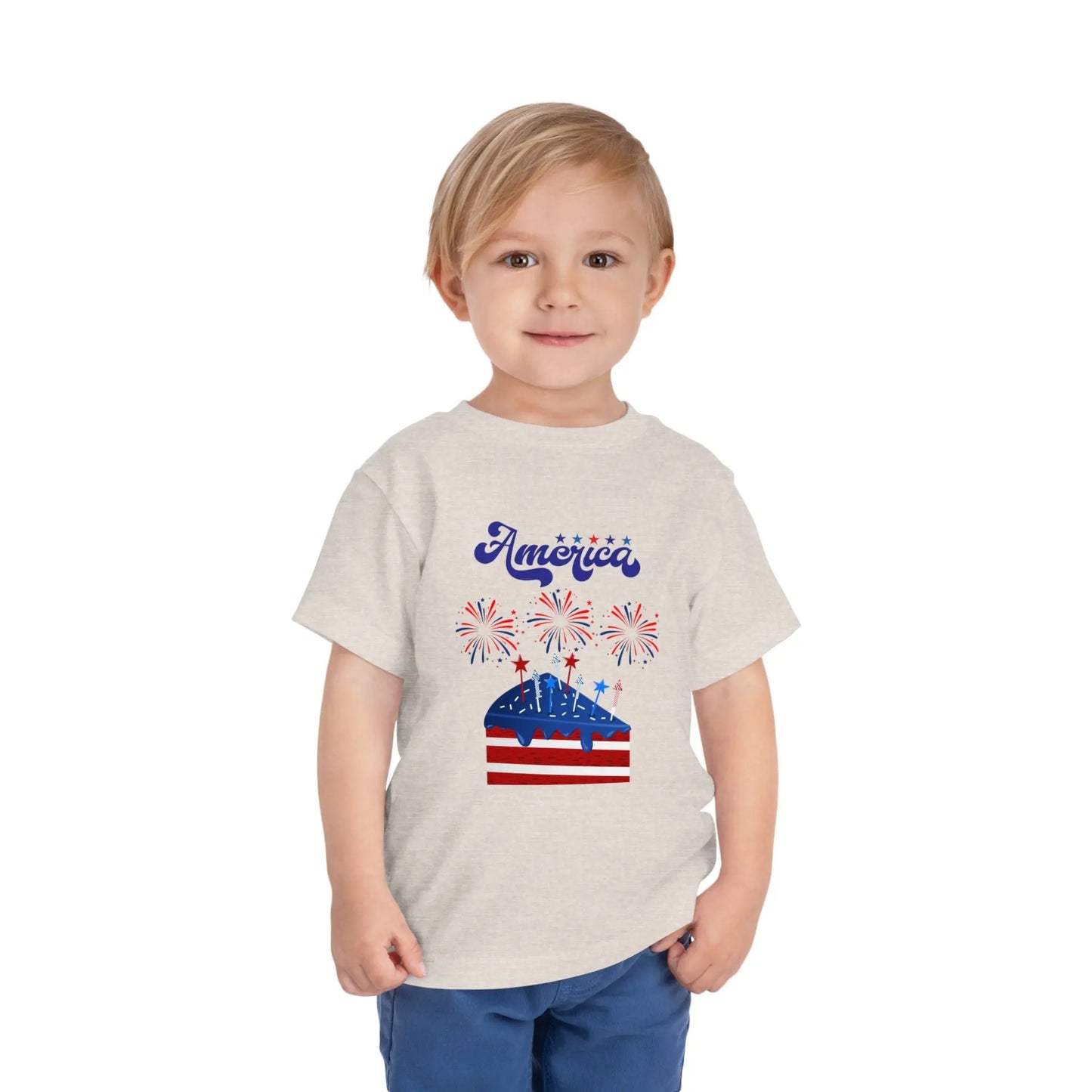 Celebrate Independence Day in style! Soft, print-on-demand 4th of July toddler tee featuring a festive flag cake and fireworks design. Sizes 2T–5T. Heather Dust