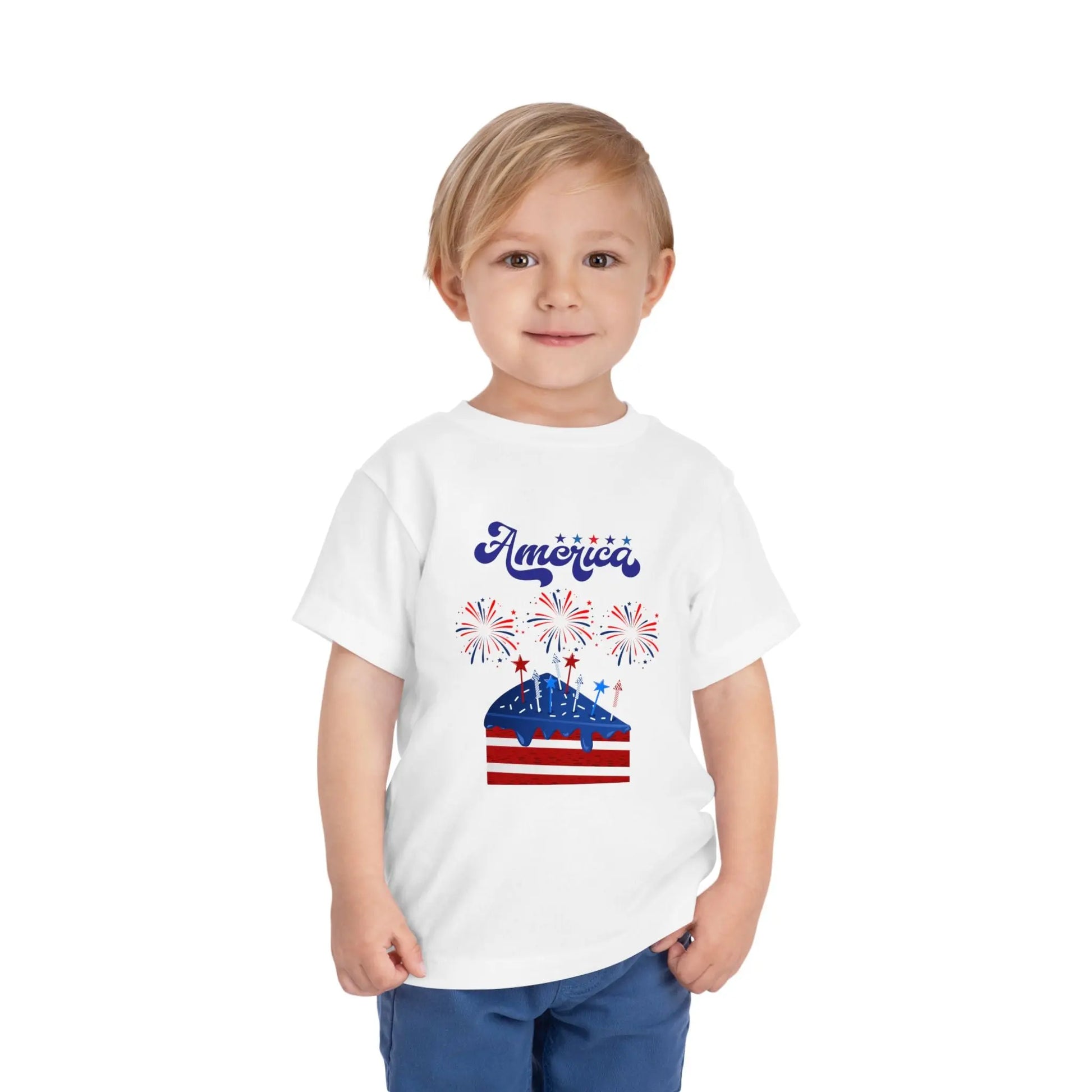Celebrate Independence Day in style! Soft, print-on-demand 4th of July toddler tee featuring a festive flag cake and fireworks design. Sizes 2T–5T. White