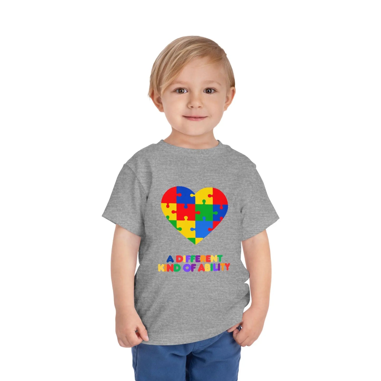 Toddler wearing an Autism Awareness t shirt honoring neurodiversity with this "A Different Kind of Ability" autism awareness toddler tee. Featuring a puzzle heart design, it's a meaningful shirt for little ones. Ash