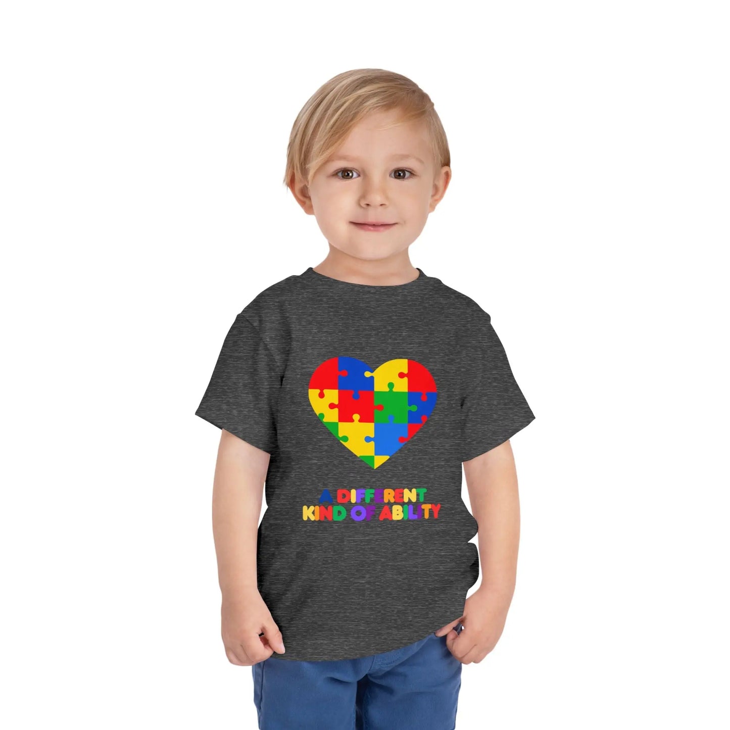 Toddler wearing an Autism Awareness t shirt honoring neurodiversity with this "A Different Kind of Ability" autism awareness toddler tee. Featuring a puzzle heart design, it's a meaningful shirt for little ones. Athletic Heather