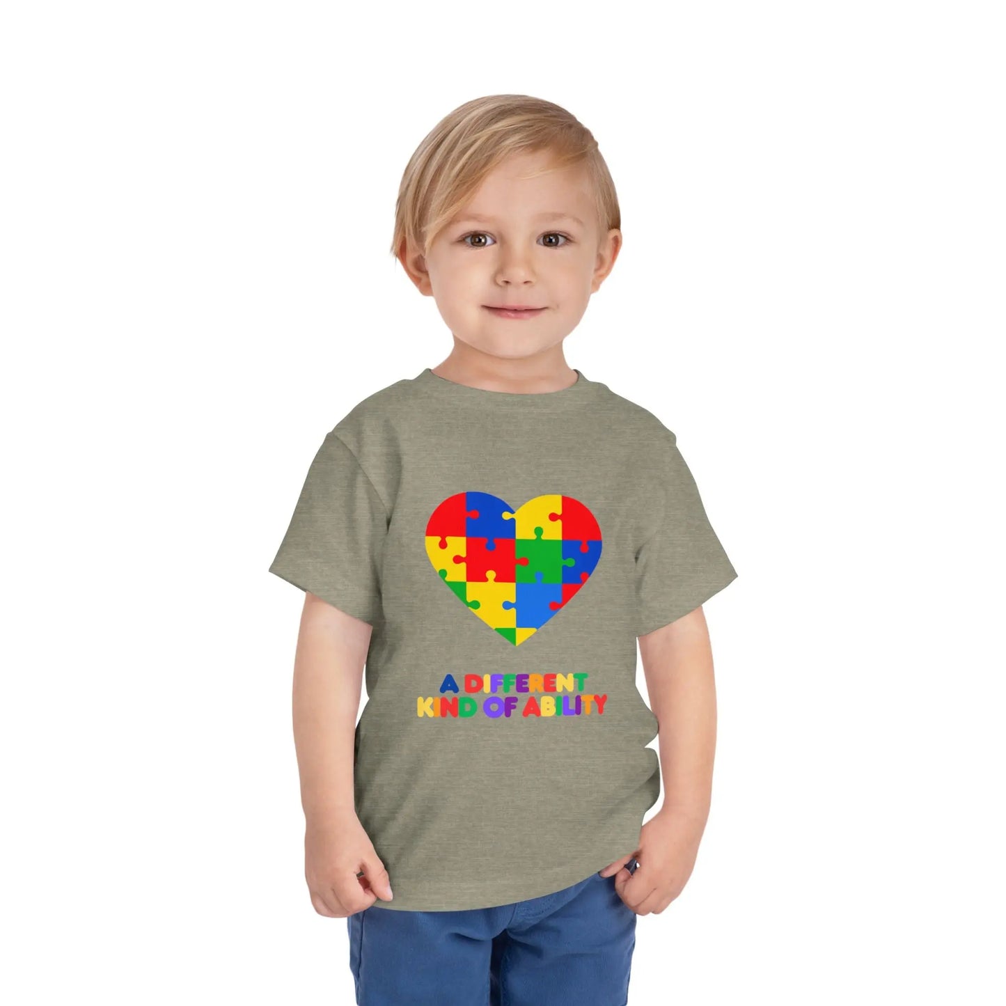 Toddler wearing an Autism Awareness t shirt honoring neurodiversity with this "A Different Kind of Ability" autism awareness toddler tee. Featuring a puzzle heart design, it's a meaningful shirt for little ones. Heather Stone