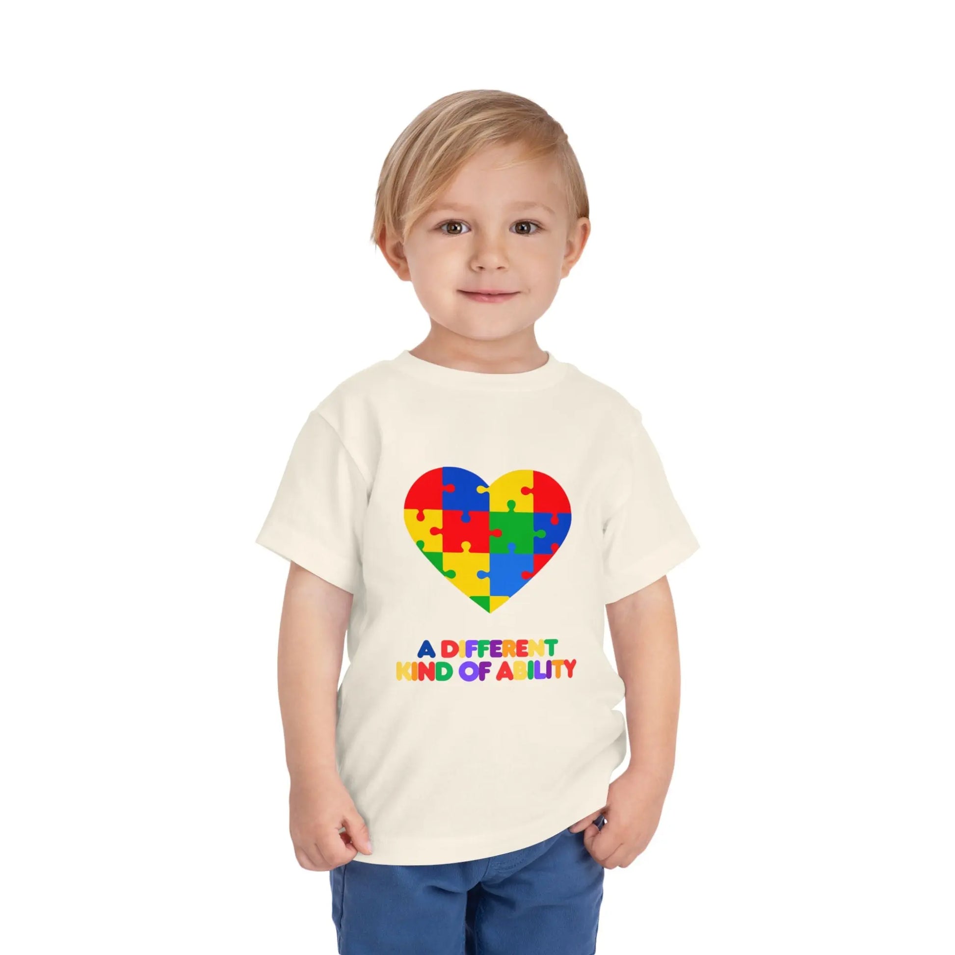 Toddler wearing an Autism Awareness t shirt honoring neurodiversity with this "A Different Kind of Ability" autism awareness toddler tee. Featuring a puzzle heart design, it's a meaningful shirt for little ones. Natural
