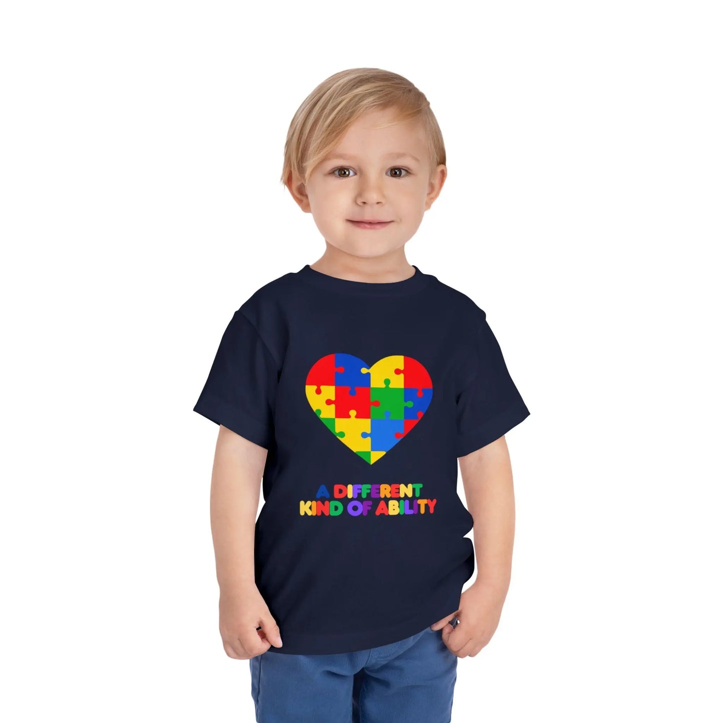 Toddler wearing an Autism Awareness t shirt honoring neurodiversity with this "A Different Kind of Ability" autism awareness toddler tee. Featuring a puzzle heart design, it's a meaningful shirt for little ones. Navy