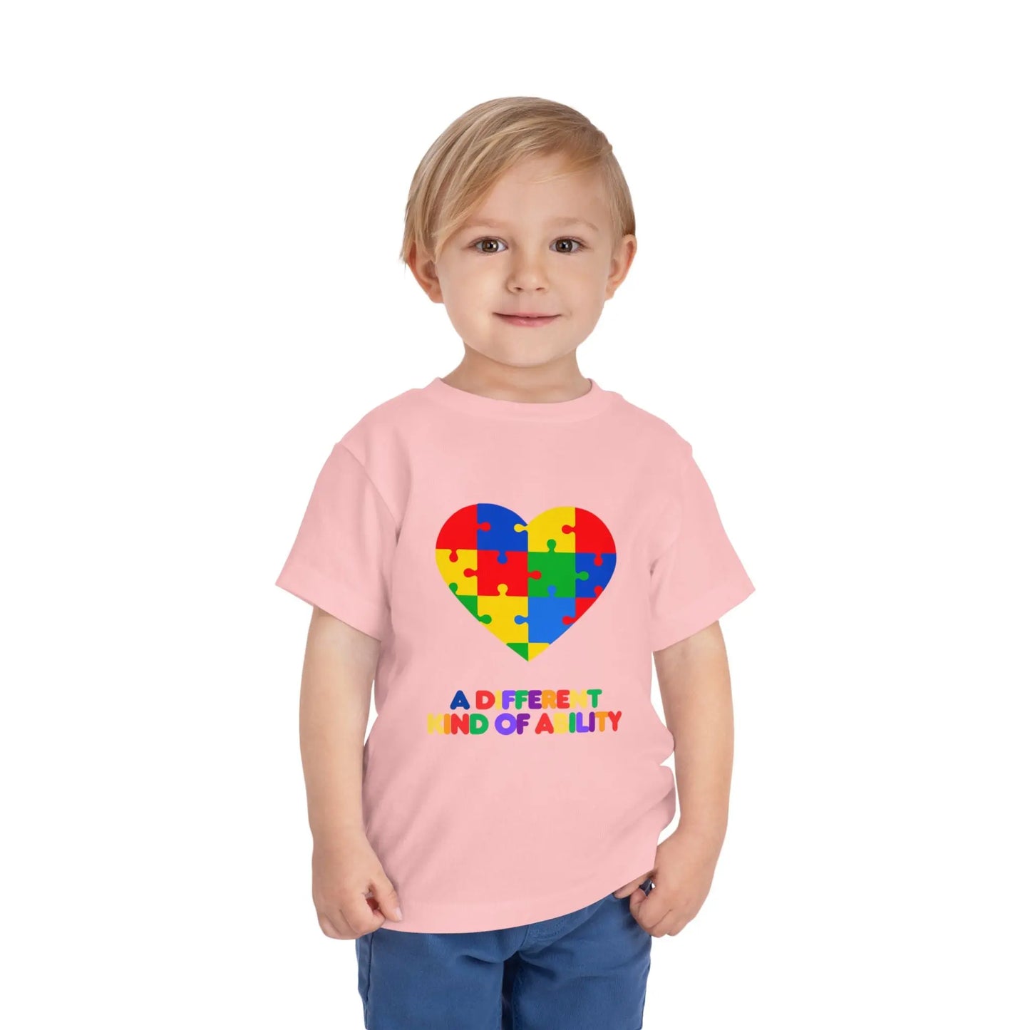 Toddler wearing an Autism Awareness t shirt honoring neurodiversity with this "A Different Kind of Ability" autism awareness toddler tee. Featuring a puzzle heart design, it's a meaningful shirt for little ones. Pink