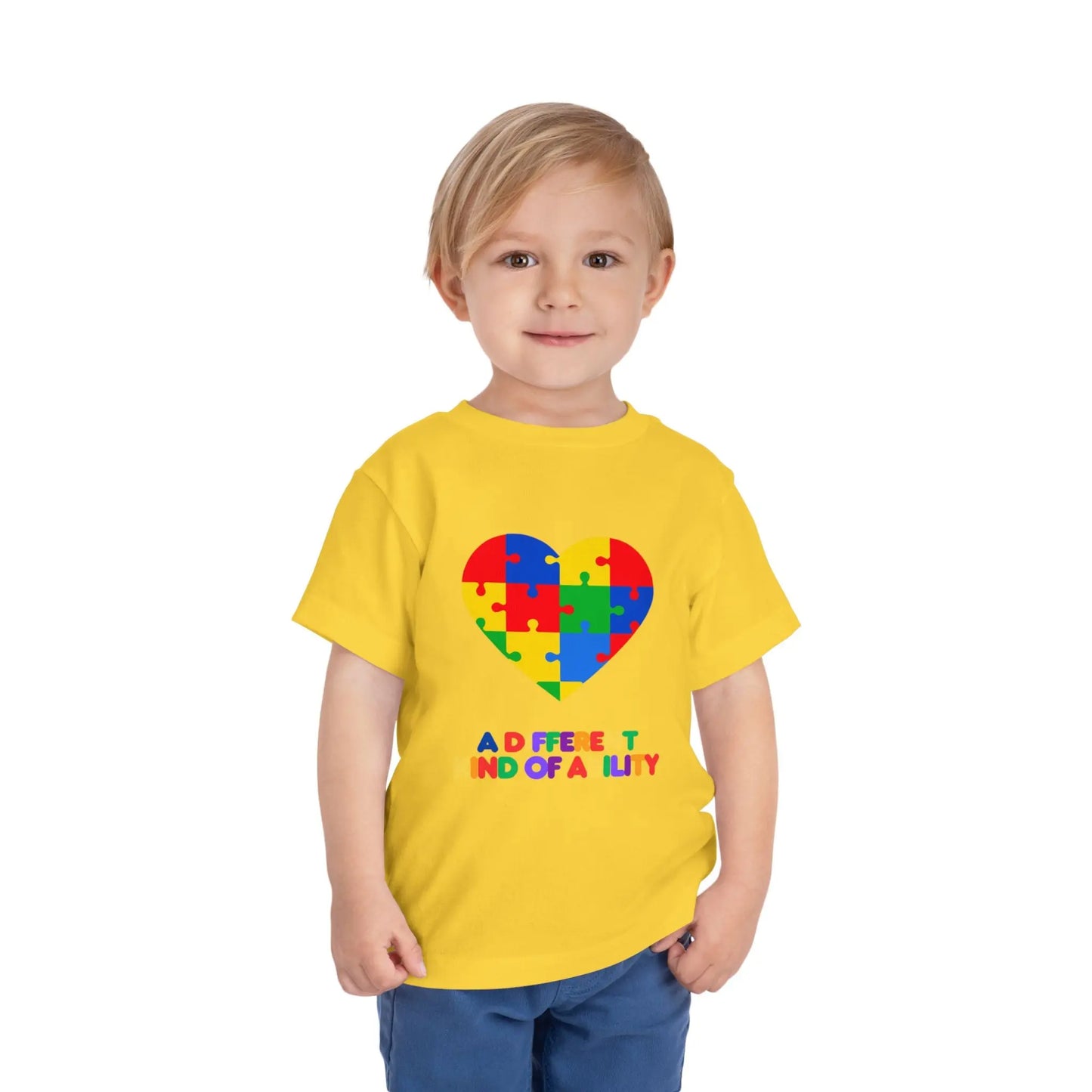 Toddler wearing an Autism Awareness t shirt honoring neurodiversity with this "A Different Kind of Ability" autism awareness toddler tee. Featuring a puzzle heart design, it's a meaningful shirt for little ones. Yellow