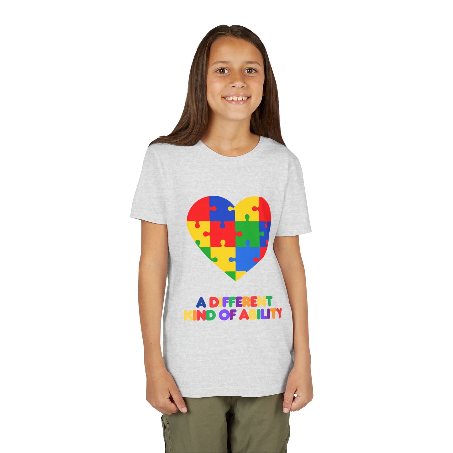 Young girl wearing an Autism Awareness Shirt. Celebrate every unique mind with this "A Different Kind of Ability" autism awareness youth tee. A puzzle heart design that spreads acceptance, love, and neurodiversity, Ash