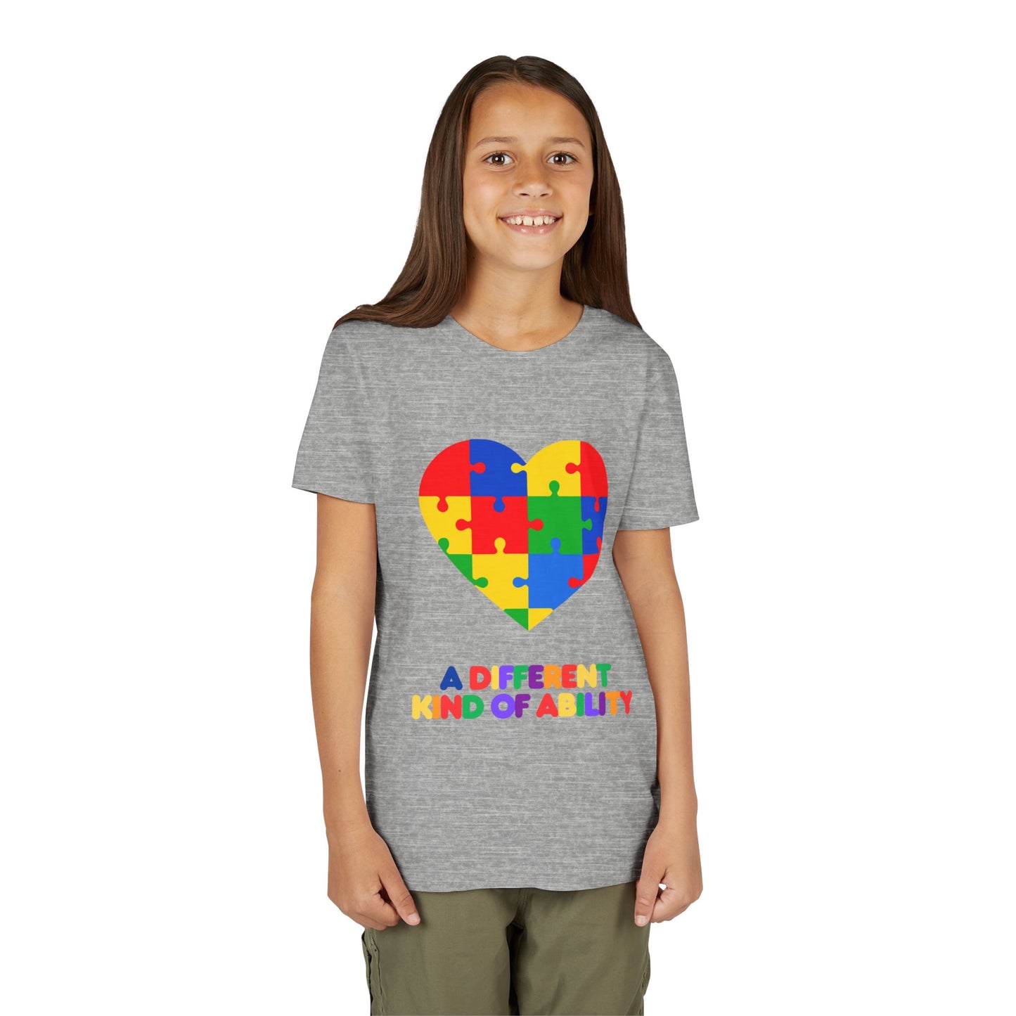 Young girl wearing an Autism Awareness Shirt. Celebrate every unique mind with this "A Different Kind of Ability" autism awareness youth tee. A puzzle heart design that spreads acceptance, love, and neurodiversity, Athletic Heather