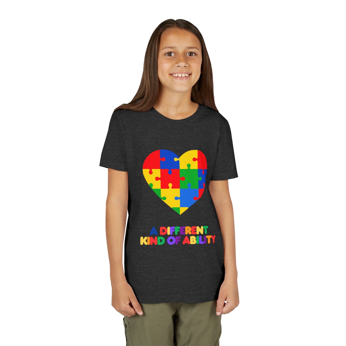 Young girl wearing an Autism Awareness Shirt. Celebrate every unique mind with this "A Different Kind of Ability" autism awareness youth tee. A puzzle heart design that spreads acceptance, love, and neurodiversity, Dark Grey Heather