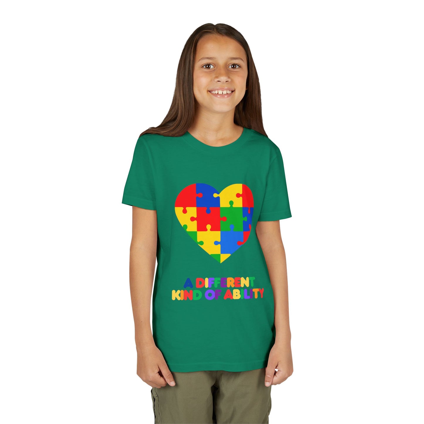 Young girl wearing an Autism Awareness Shirt. Celebrate every unique mind with this "A Different Kind of Ability" autism awareness youth tee. A puzzle heart design that spreads acceptance, love, and neurodiversity, Kelly Green
