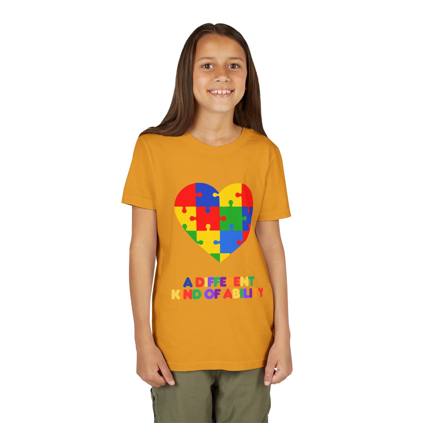 Young girl wearing an Autism Awareness Shirt. Celebrate every unique mind with this "A Different Kind of Ability" autism awareness youth tee. A puzzle heart design that spreads acceptance, love, and neurodiversity, Mustard