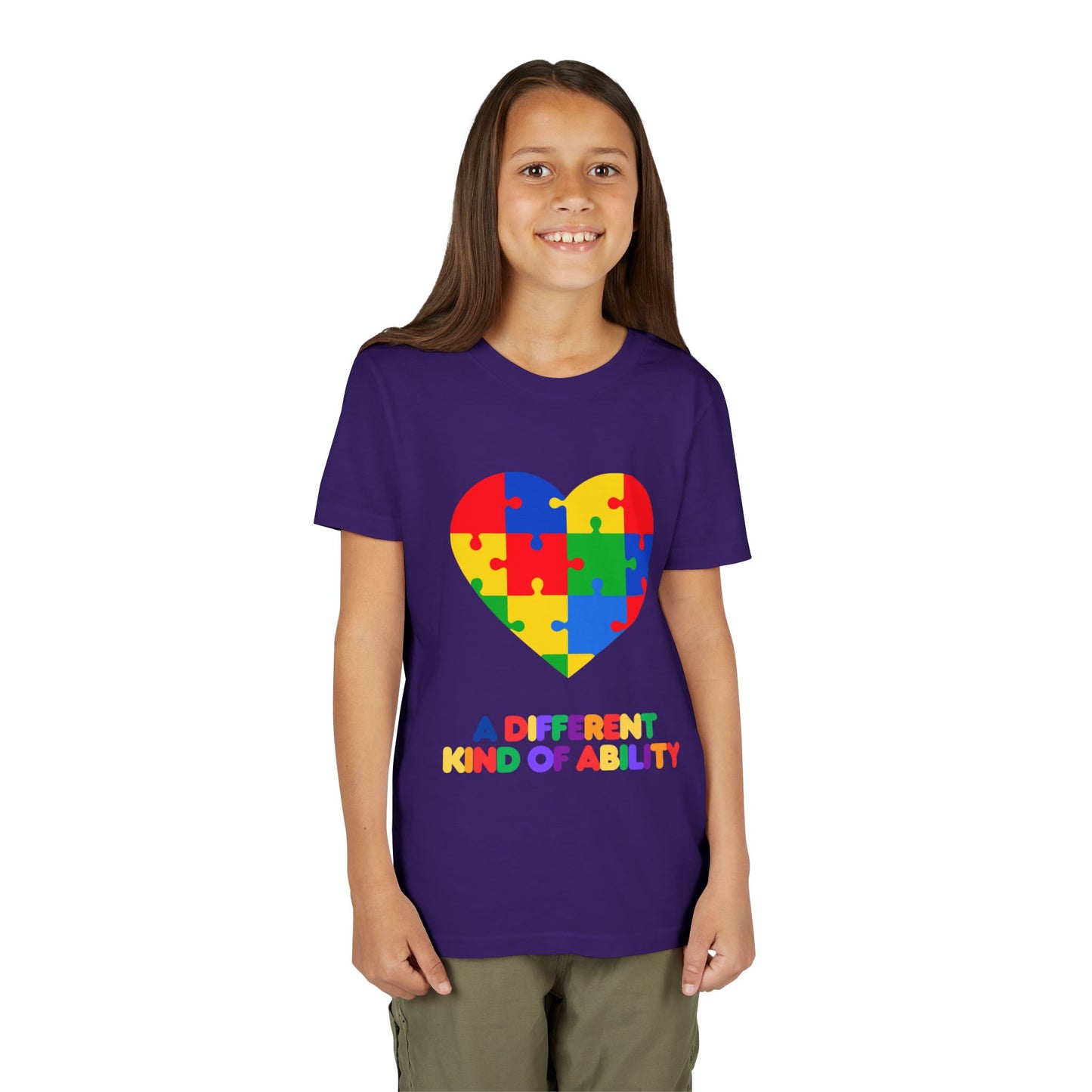Young girl wearing an Autism Awareness Shirt. Celebrate every unique mind with this "A Different Kind of Ability" autism awareness youth tee. A puzzle heart design that spreads acceptance, love, and neurodiversity, Team Purple