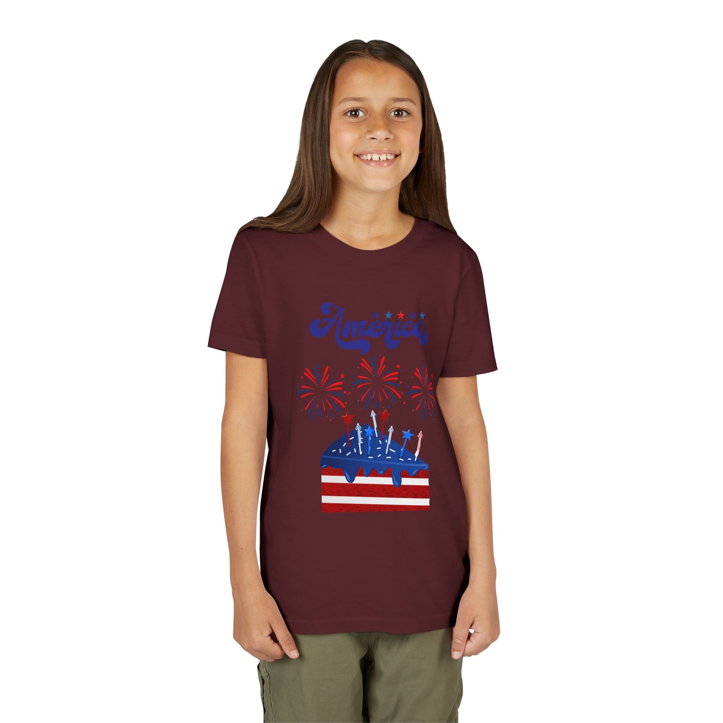 Child wearing a Maroon t-shirt with a graphic design on a white background. Celebrate the 4th of July in style! This patriotic America fireworks youth tee is perfect for kids who love Independence Day festivities and summer fun.