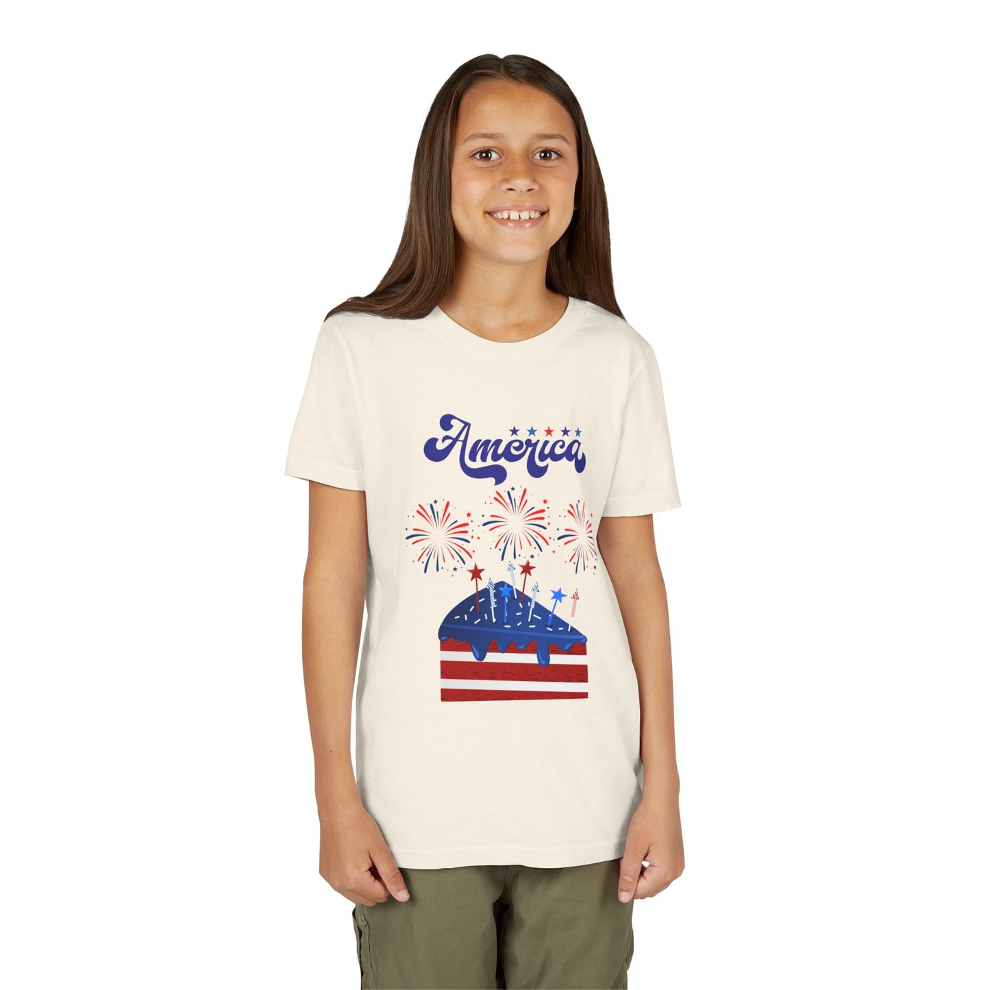 Young girl wearing a t-shirt with 'America' and a graphic design on a white background. Celebrate the 4th of July in style! This patriotic America fireworks youth tee is perfect for kids who love Independence Day festivities and summer fun. Natural