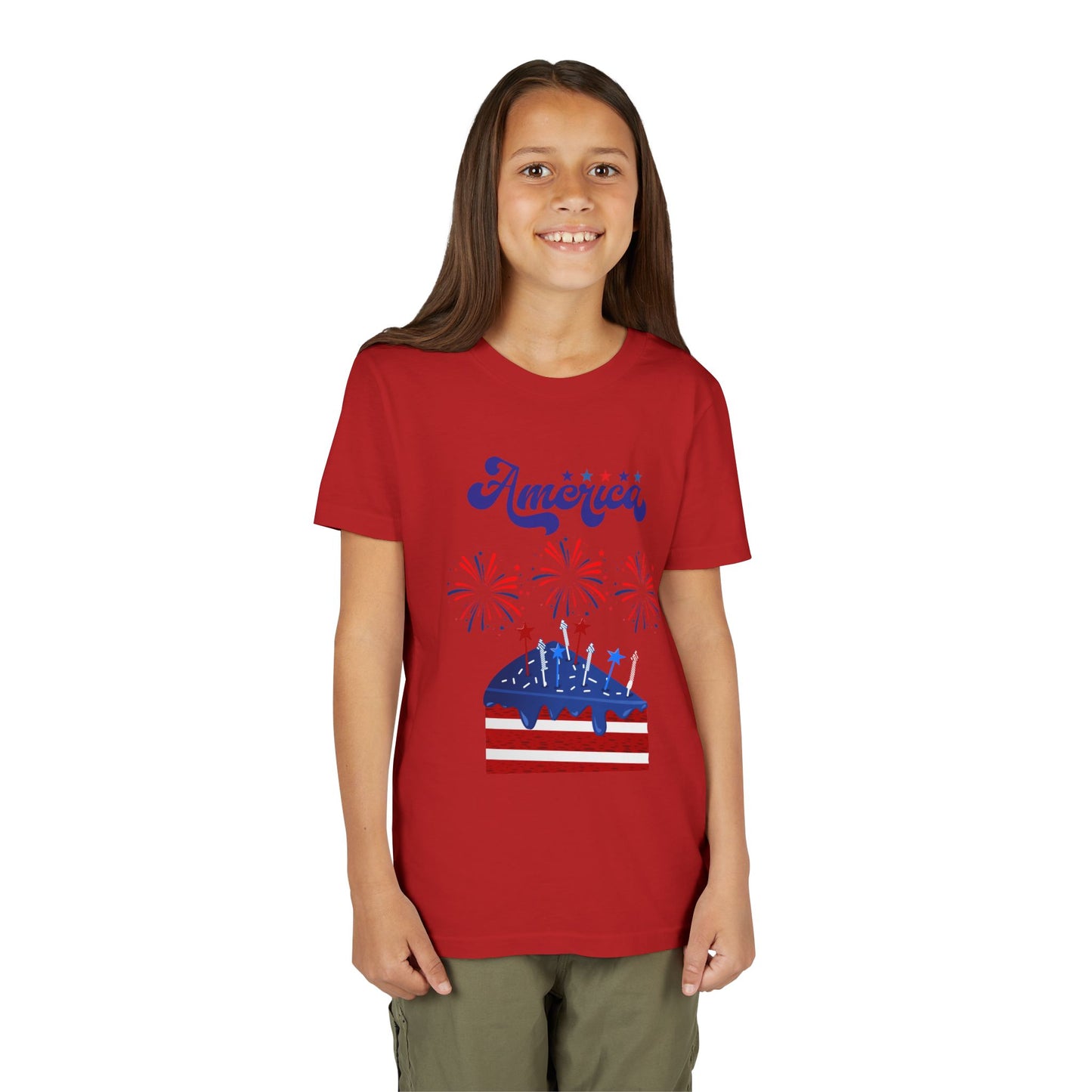 Child wearing a Red t-shirt with a graphic design on a white background. Celebrate the 4th of July in style! This patriotic America fireworks youth tee is perfect for kids who love Independence Day festivities and summer fun.