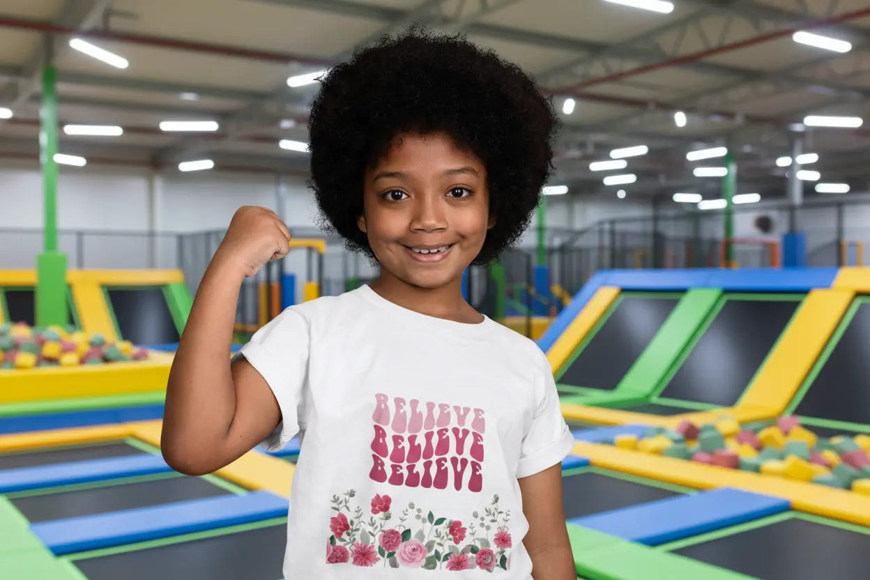 Toddler wearing Believe tee with retro pink script and hand-painted rose bouquet, White
