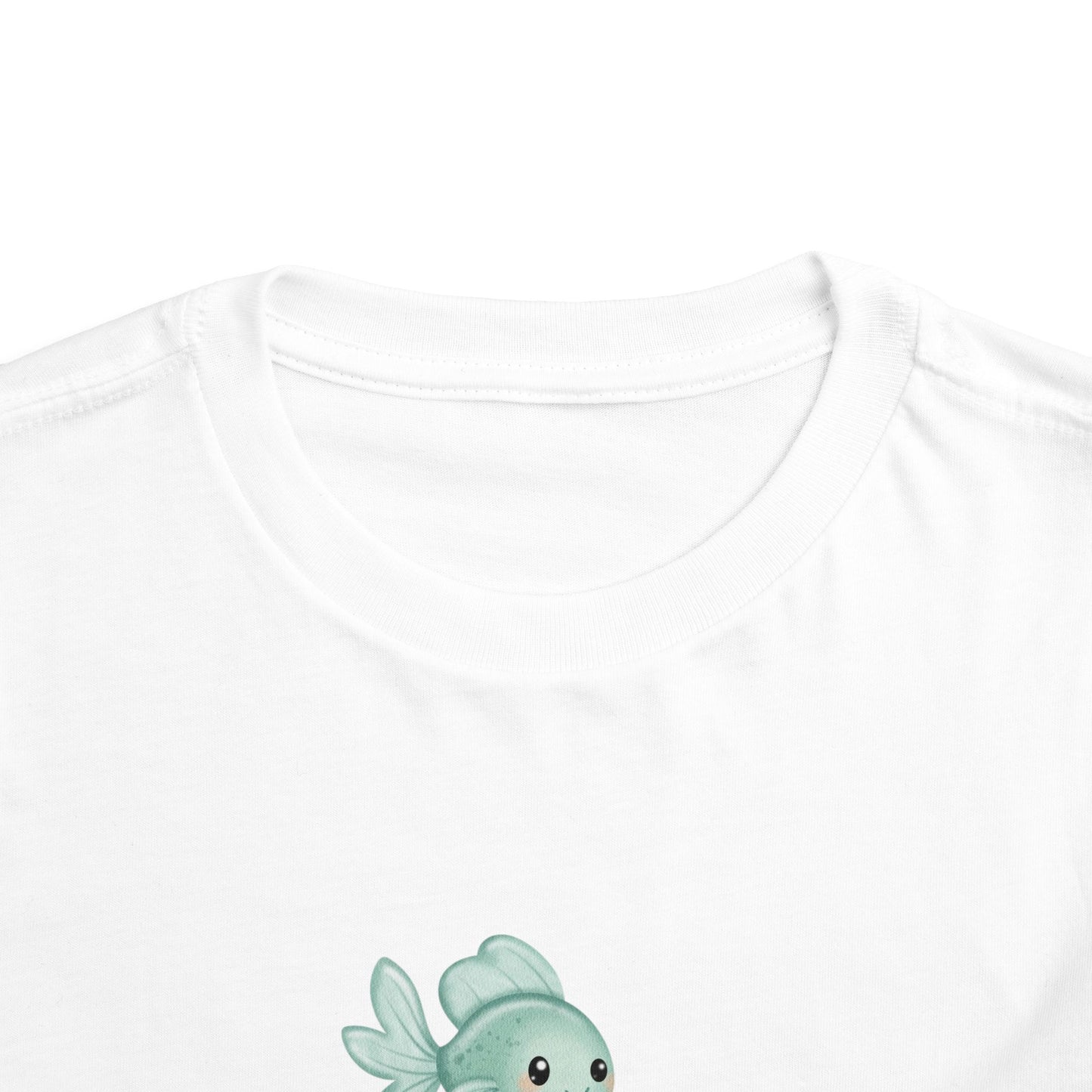 White t-shirt with a small green fish design on a white background
