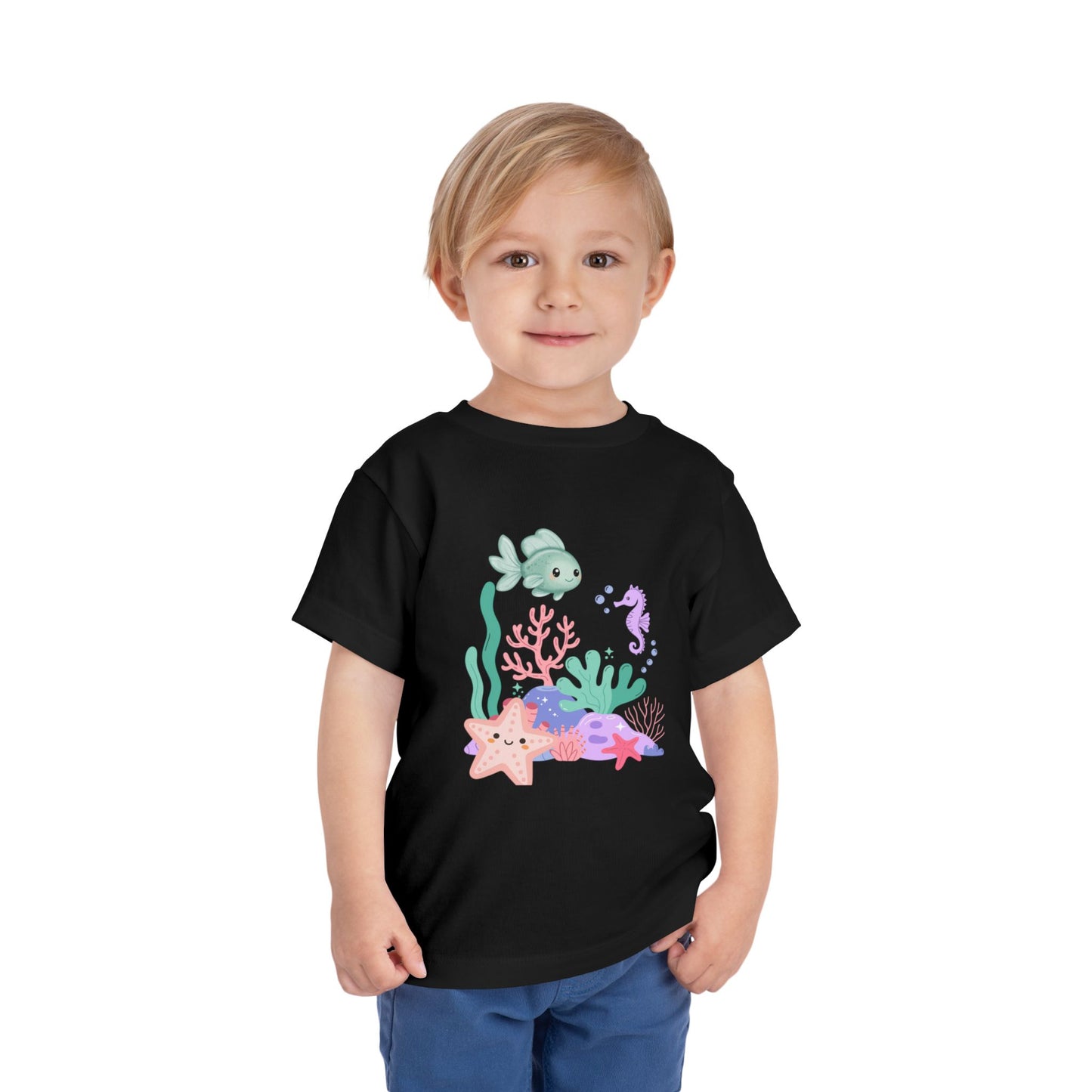 Child wearing a soft, breathable toddler tee featuring pastel sea creatures — fish, seahorse & starfish. Tear-away label, lightweight fabric. Sizes 2T–5T. Shop now! Black