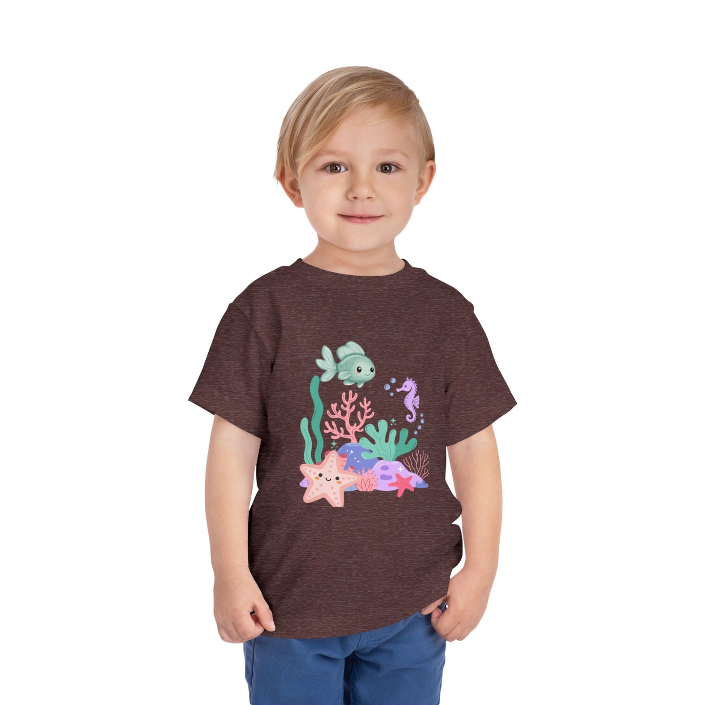 Child wearing a soft, breathable toddler tee featuring pastel sea creatures — fish, seahorse & starfish. Tear-away label, lightweight fabric. Sizes 2T–5T. Shop now! Heather Maroon