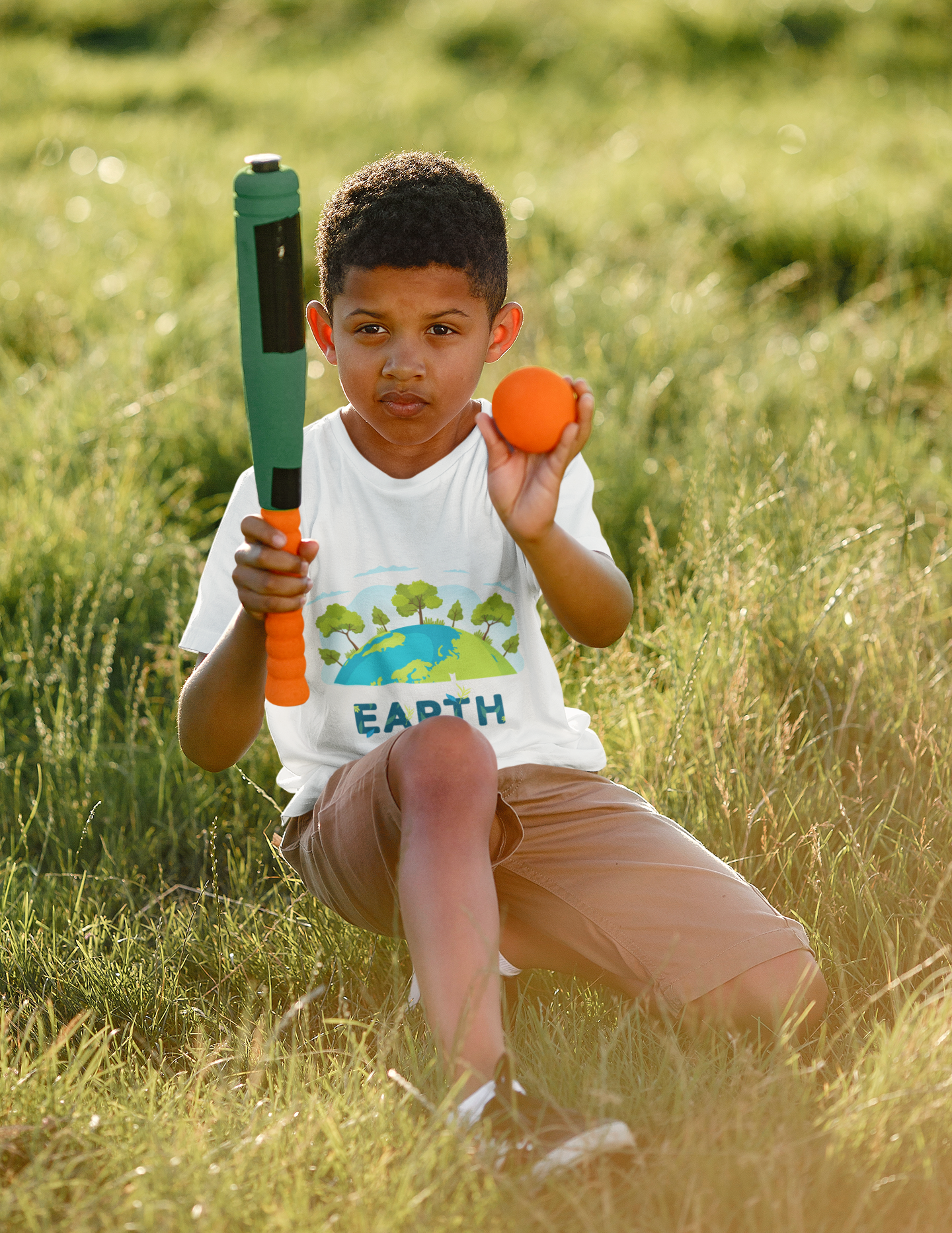 Youth wearing Happy Earth Day tee with tree and globe graphic design.
White