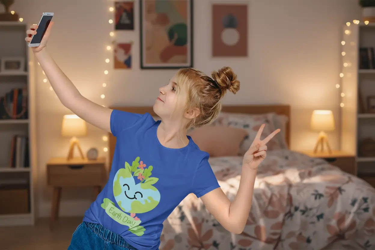 Youth wearing Earth Day tee with smiling heart-shaped Earth and leaf design, True Royal
