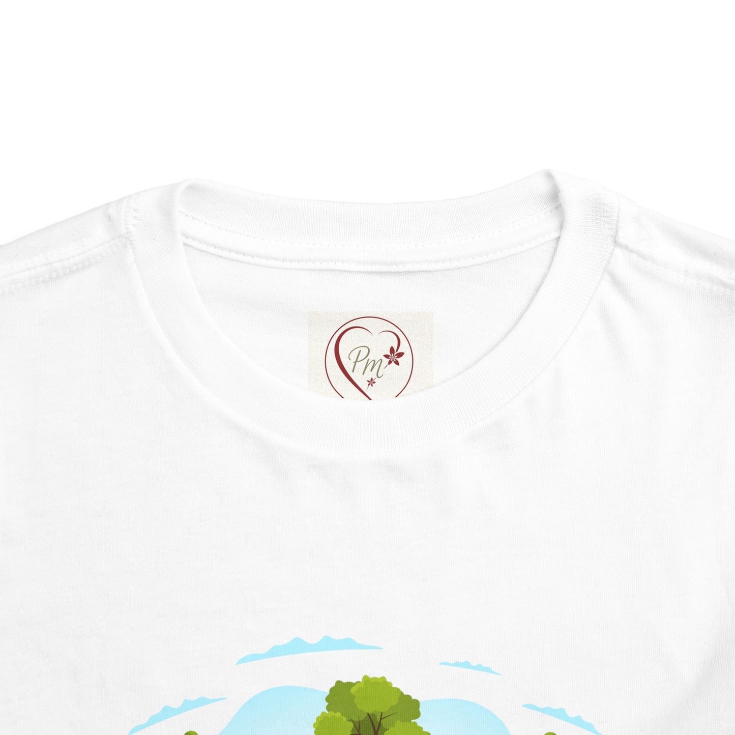 White t-shirt with a scenic design and a PM Creations 25 logo on the collar