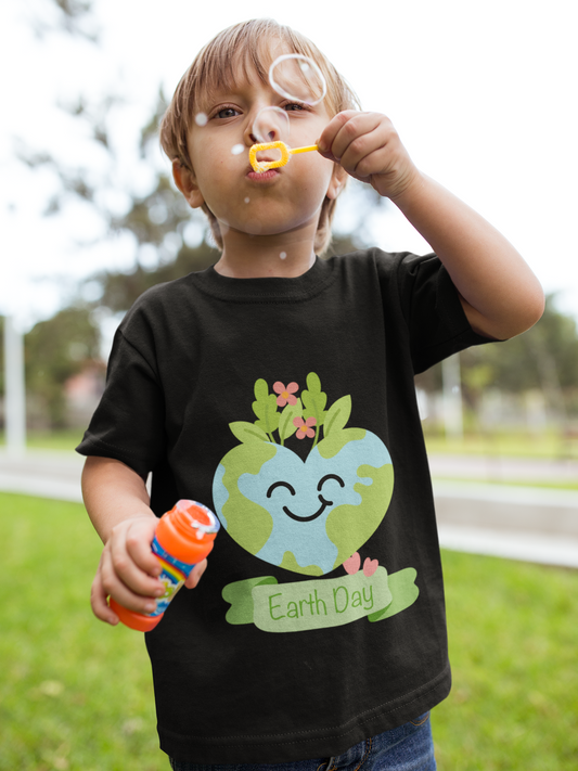 Toddler wearing Earth Day tee with smiling planet crowned with leaves and flowers in Black