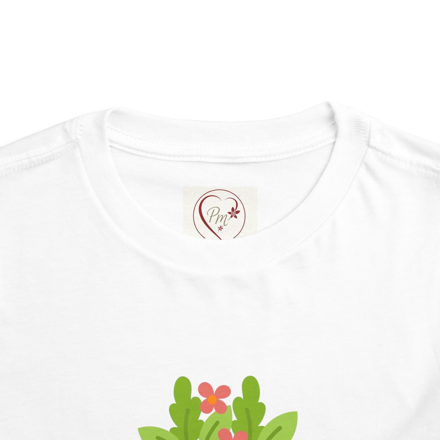 White t-shirt with a PM Creations 25 logo and floral design on a white background