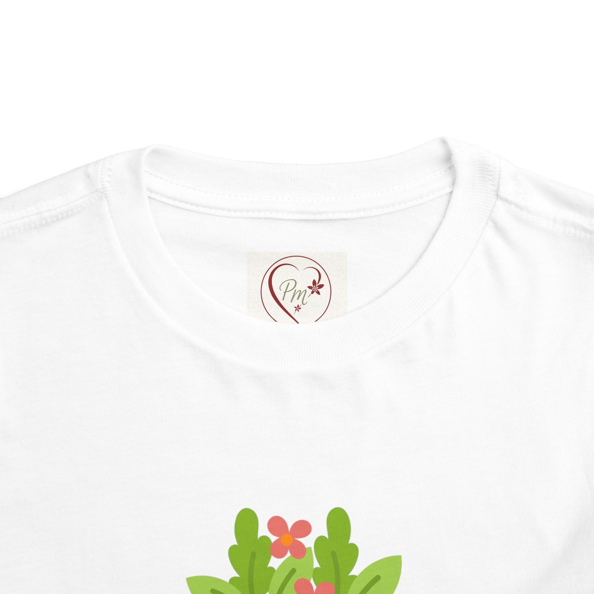 White t-shirt with a PM Creations 25 logo and floral design on a white background