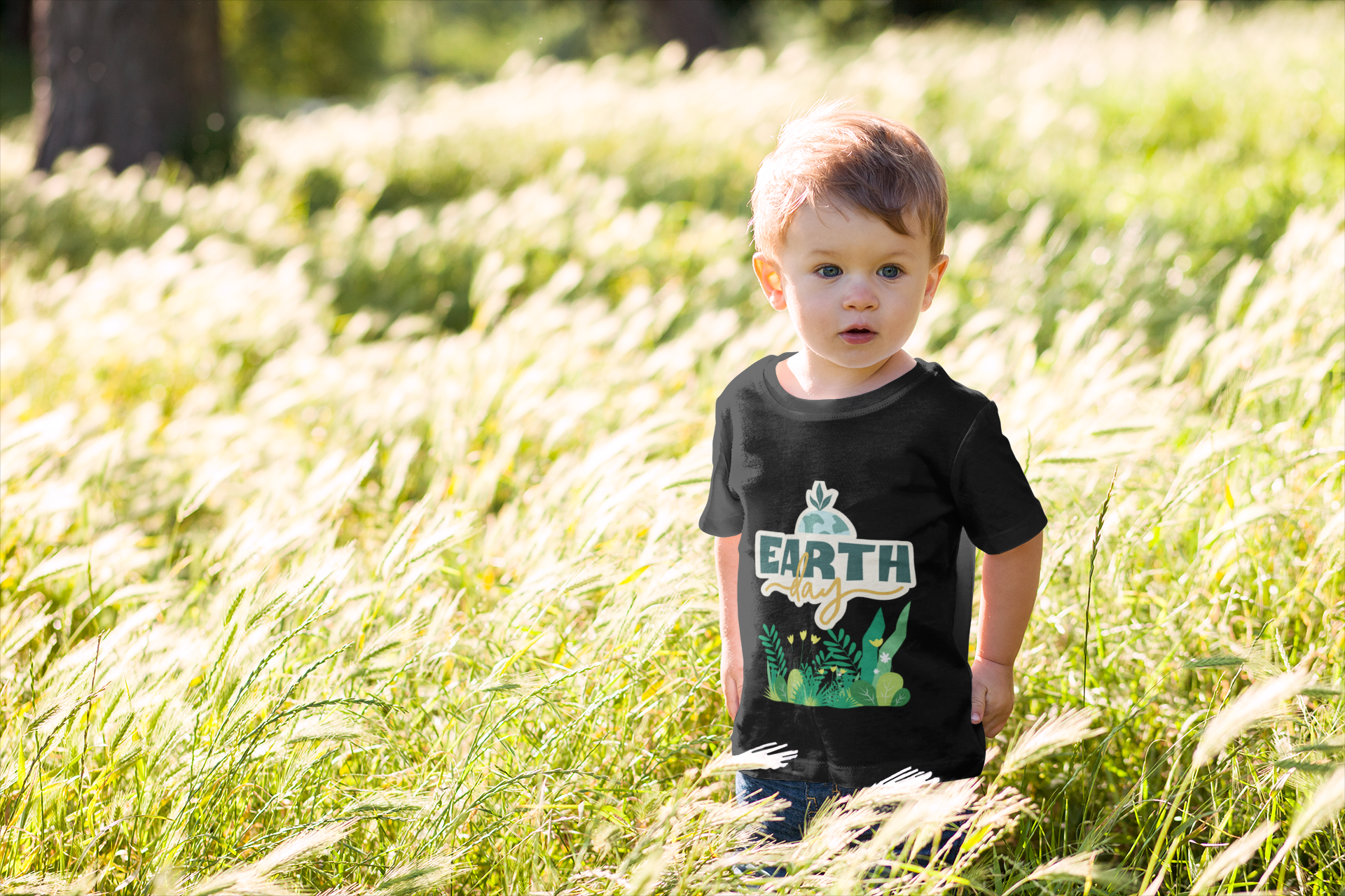 Toddler wearing Earth Day tee with green leafy plant design black
