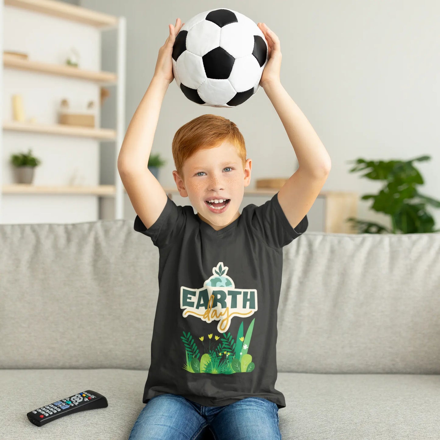 Youth wearing Earth Day tee with green leafy foliage design, Asphalt
