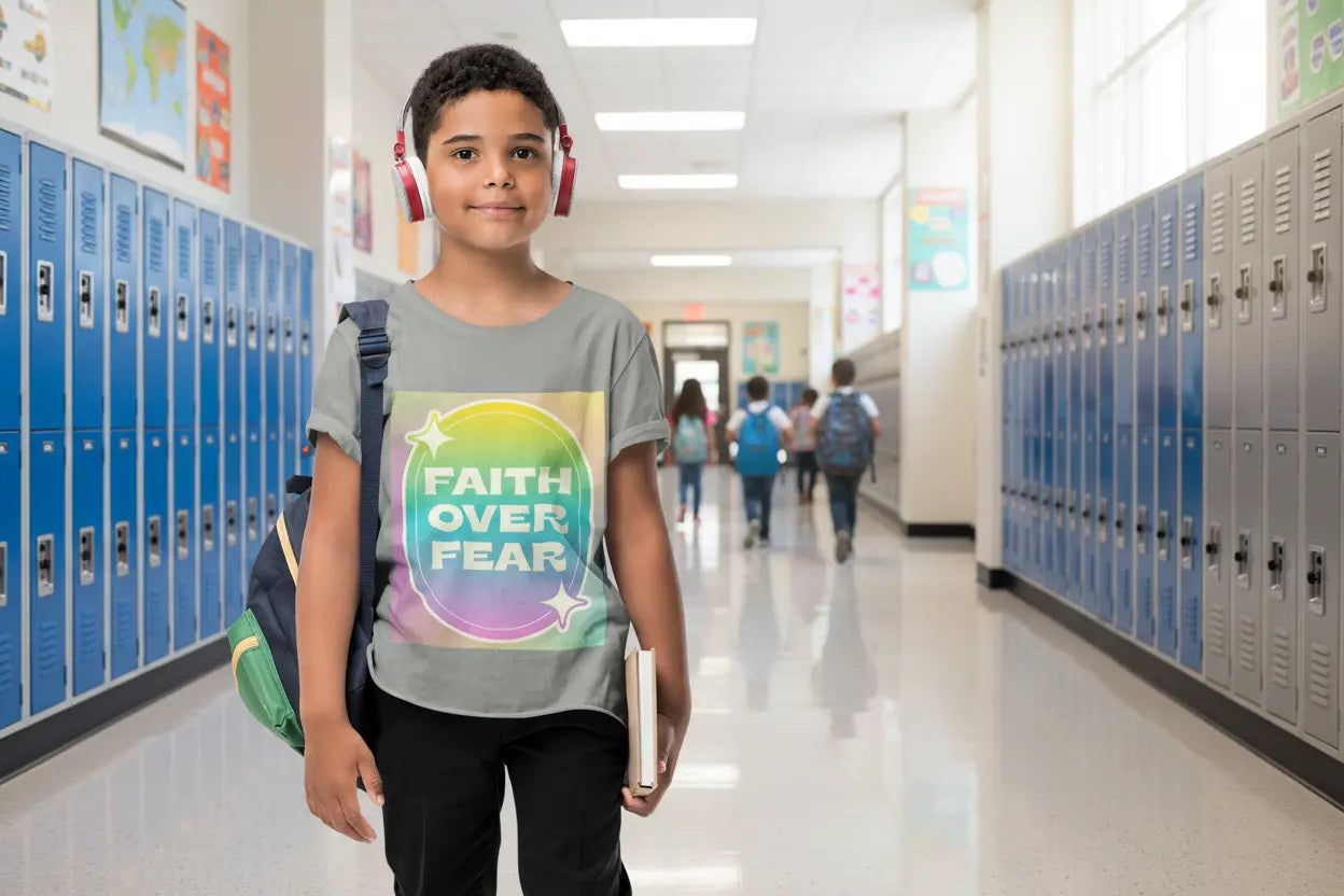 Youth wearing a soft, colorful youth tee with uplifting "Faith Over Fear" message. Lightweight cotton, perfect for church, Sunday school, or everyday wear. Inspiring kids' apparel. Asphalt