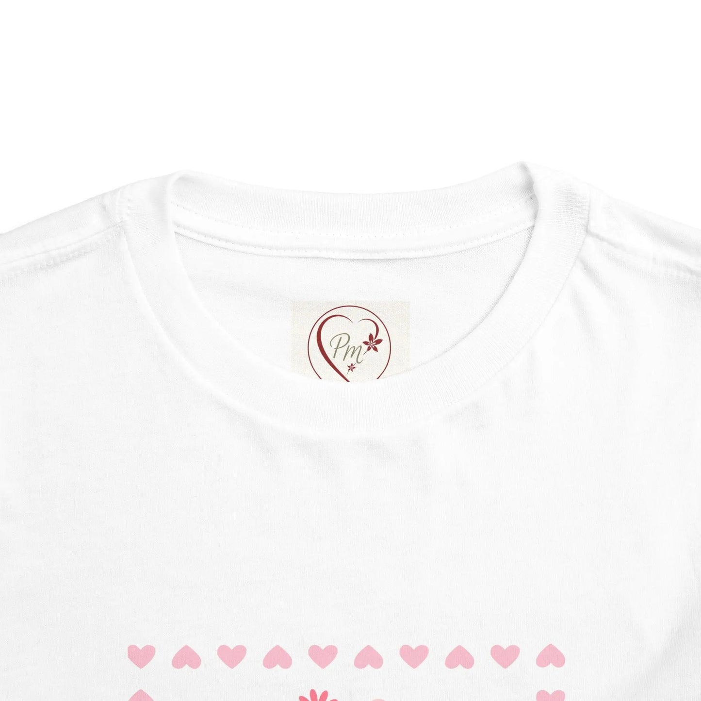 White t-shirt with a heart-shaped PM Creations 25 logo and pink heart patterns on a white background