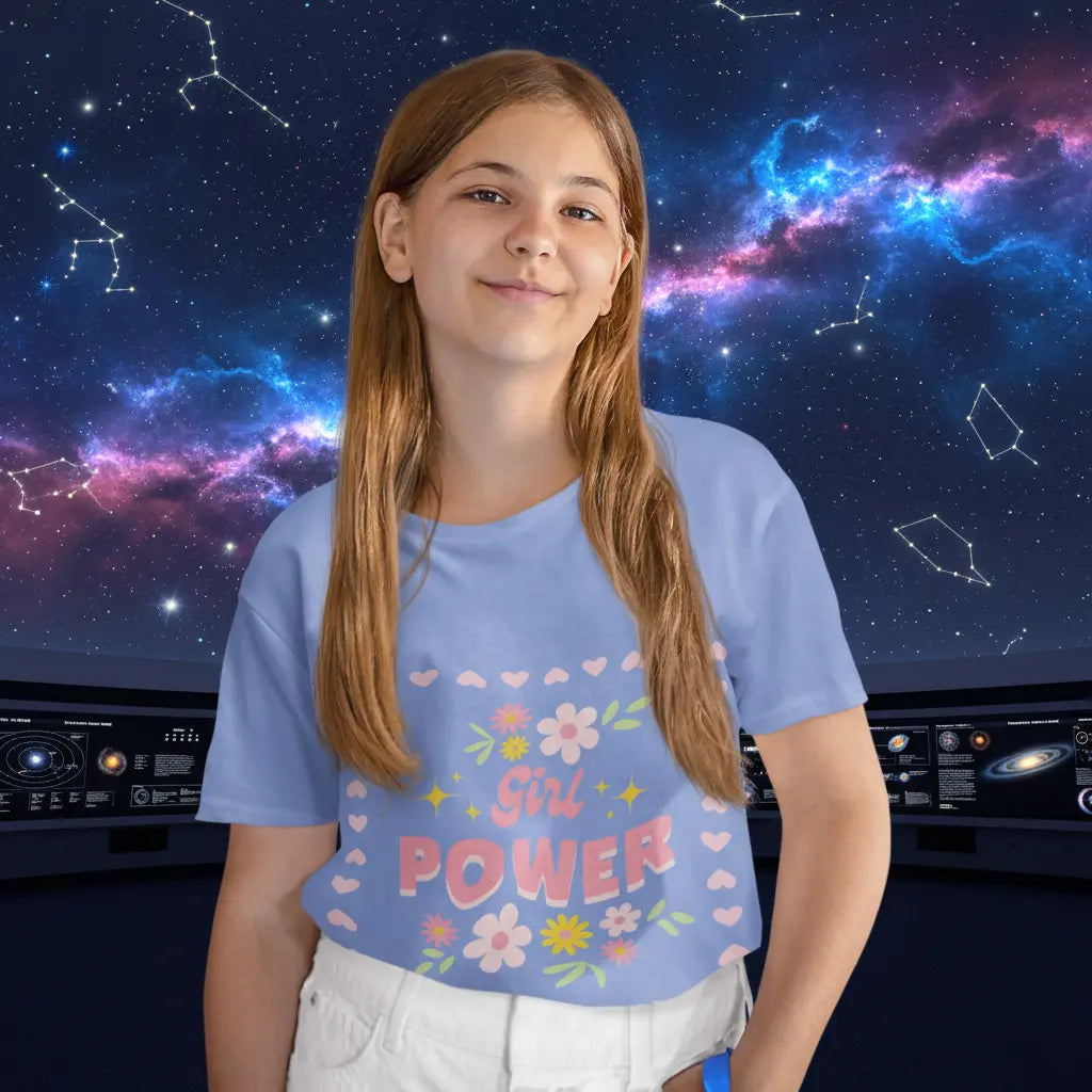 Young girl wearing, soft youth tee with a floral Girl Power design in pink. Lightweight Bella+Canvas, sizes S–XL. Perfect for school, playdates & gifting. Heather Columbia Blue