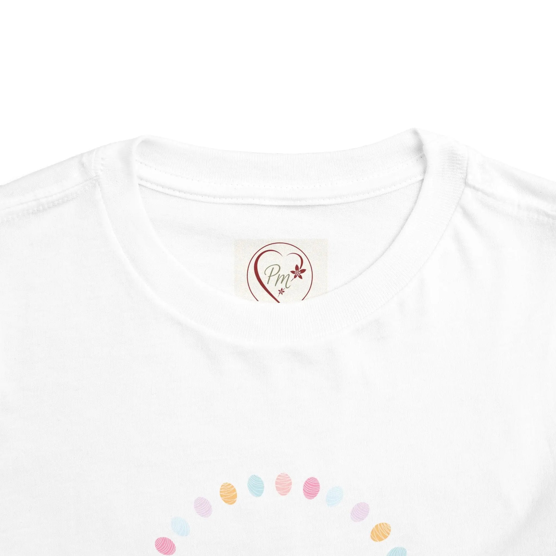 Soft cotton toddler tee perfect for Easter egg hunts, church, and spring celebrations. Cheerful bunny and egg design. Comfortable and cute. Sizes 2T-5T. Neck label, PM Creations 25 Logo