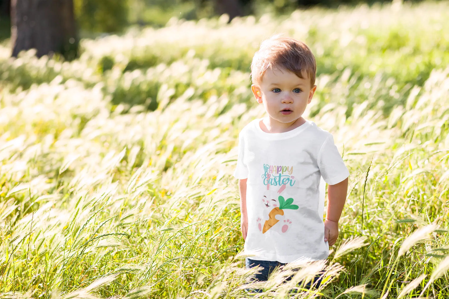 Toddler wearing Happy Easter tee with sleepy bunny holding bright carrot,
White