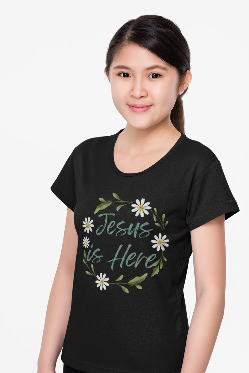 A soft, floral "Jesus is Here" youth Christian tee — a gentle reminder of God's presence for little ones. Perfect for church, Sunday school, baptisms, and everyday faith wear.