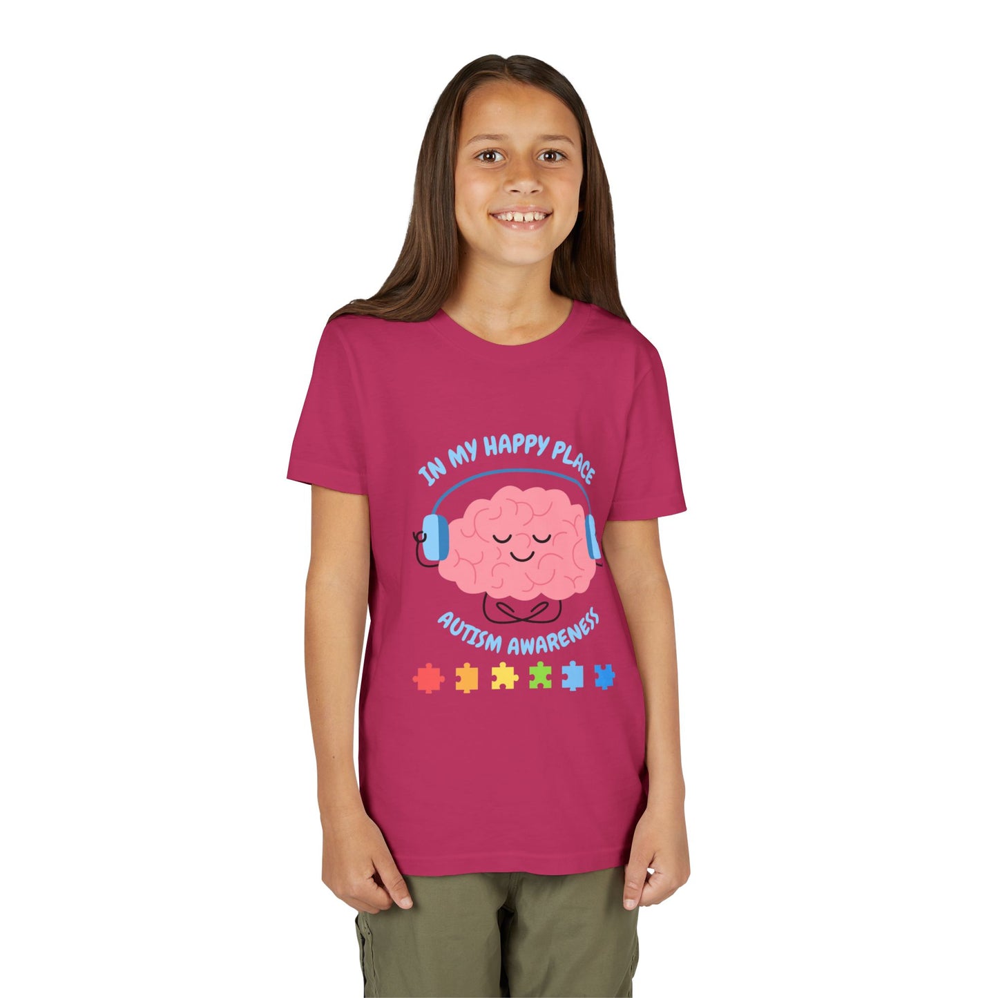 Girl wearing a youth tee for Autism Awareness with smiling brain with headphones and colorful puzzle pieces, "In My Happy Place" graphic. Berry