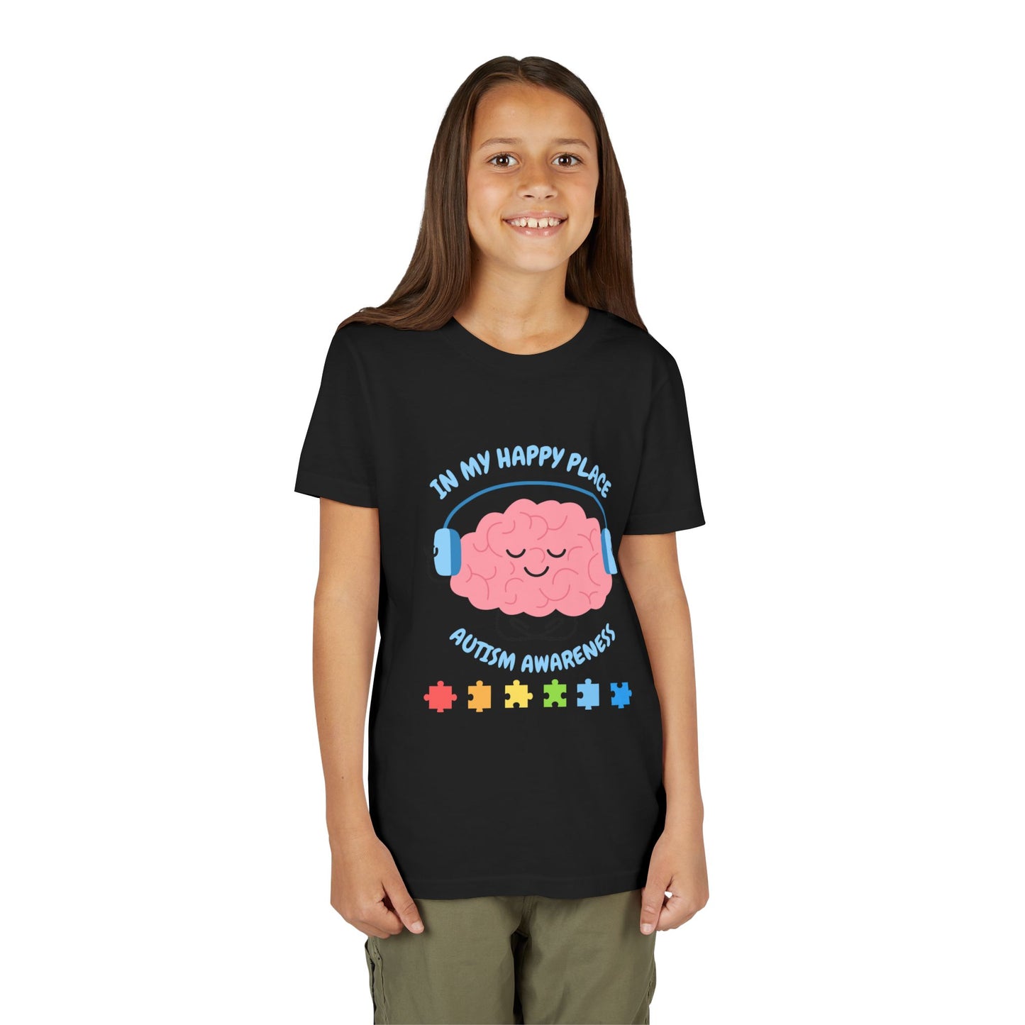 Girl wearing a youth tee for Autism Awareness with smiling brain with headphones and colorful puzzle pieces, "In My Happy Place" graphic. Black