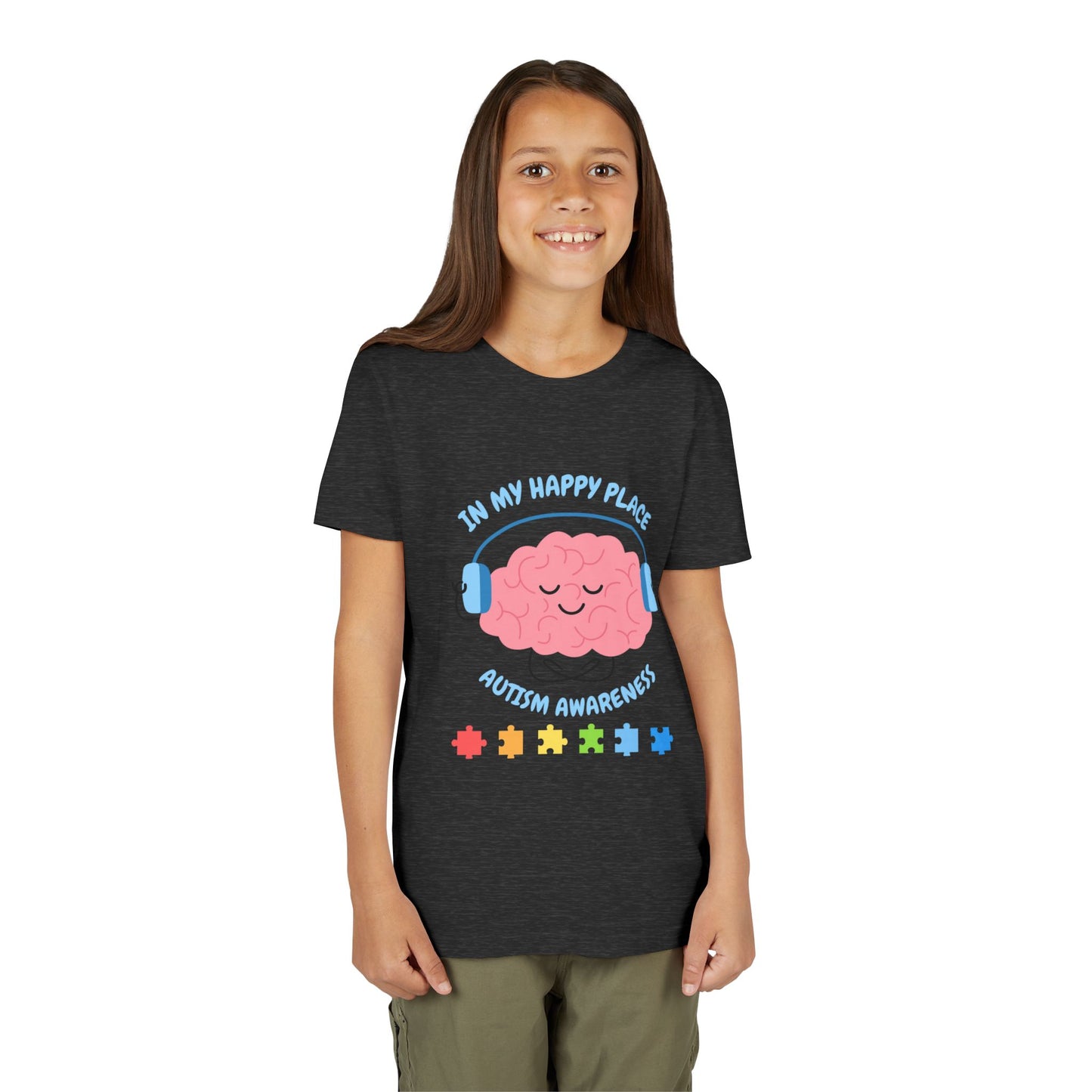 Girl wearing a youth tee for Autism Awareness with smiling brain with headphones and colorful puzzle pieces, "In My Happy Place" graphic. Dark Grey Heather