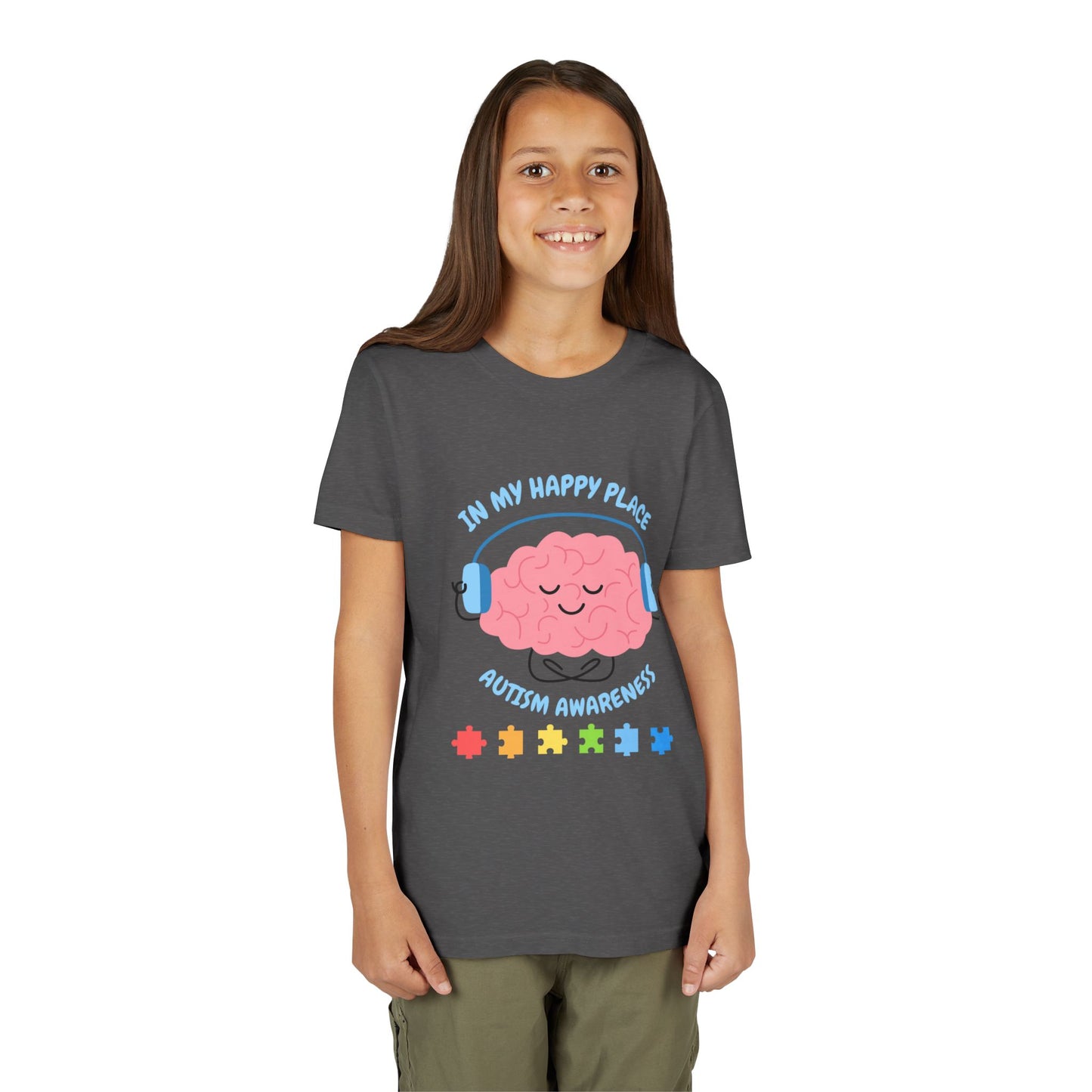 Girl wearing a youth tee for Autism Awareness with smiling brain with headphones and colorful puzzle pieces, "In My Happy Place" graphic. Dark Heather Grey