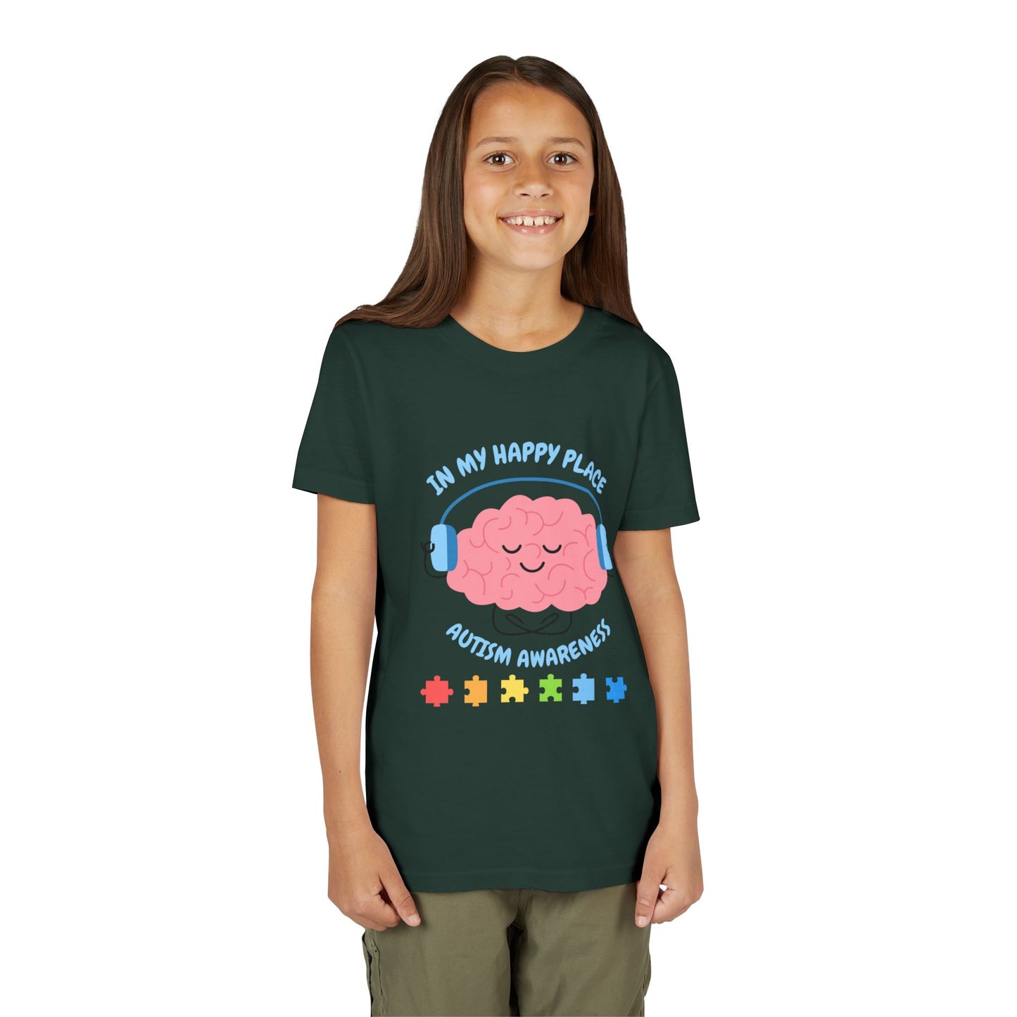 Girl wearing a youth tee for Autism Awareness with smiling brain with headphones and colorful puzzle pieces, "In My Happy Place" graphic. Forest