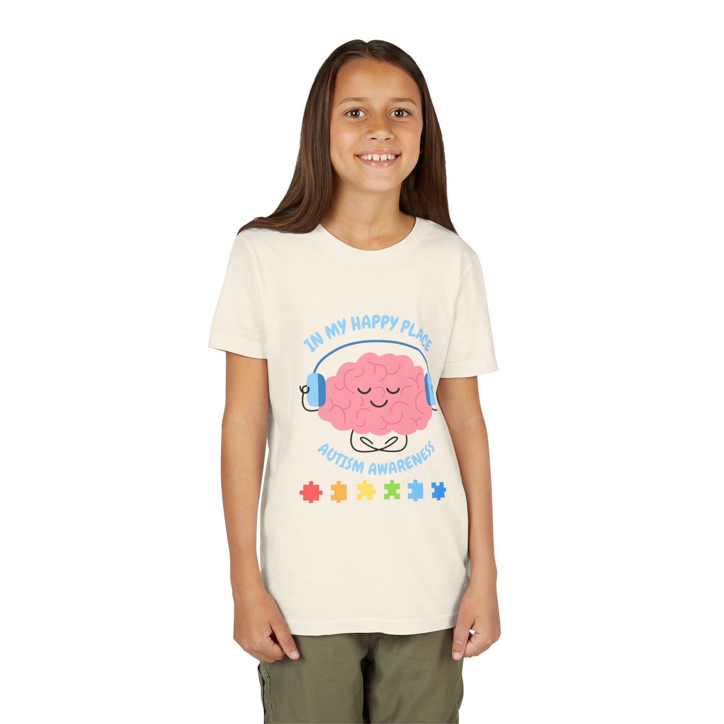Girl wearing a youth tee for Autism Awareness with smiling brain with headphones and colorful puzzle pieces, "In My Happy Place" graphic. Natural