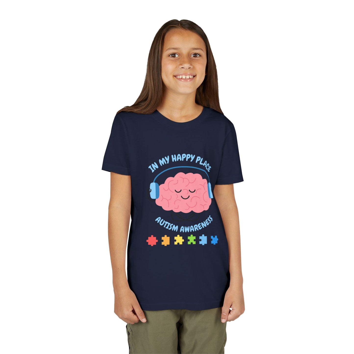 Girl wearing a youth tee for Autism Awareness with smiling brain with headphones and colorful puzzle pieces, "In My Happy Place" graphic. Navy