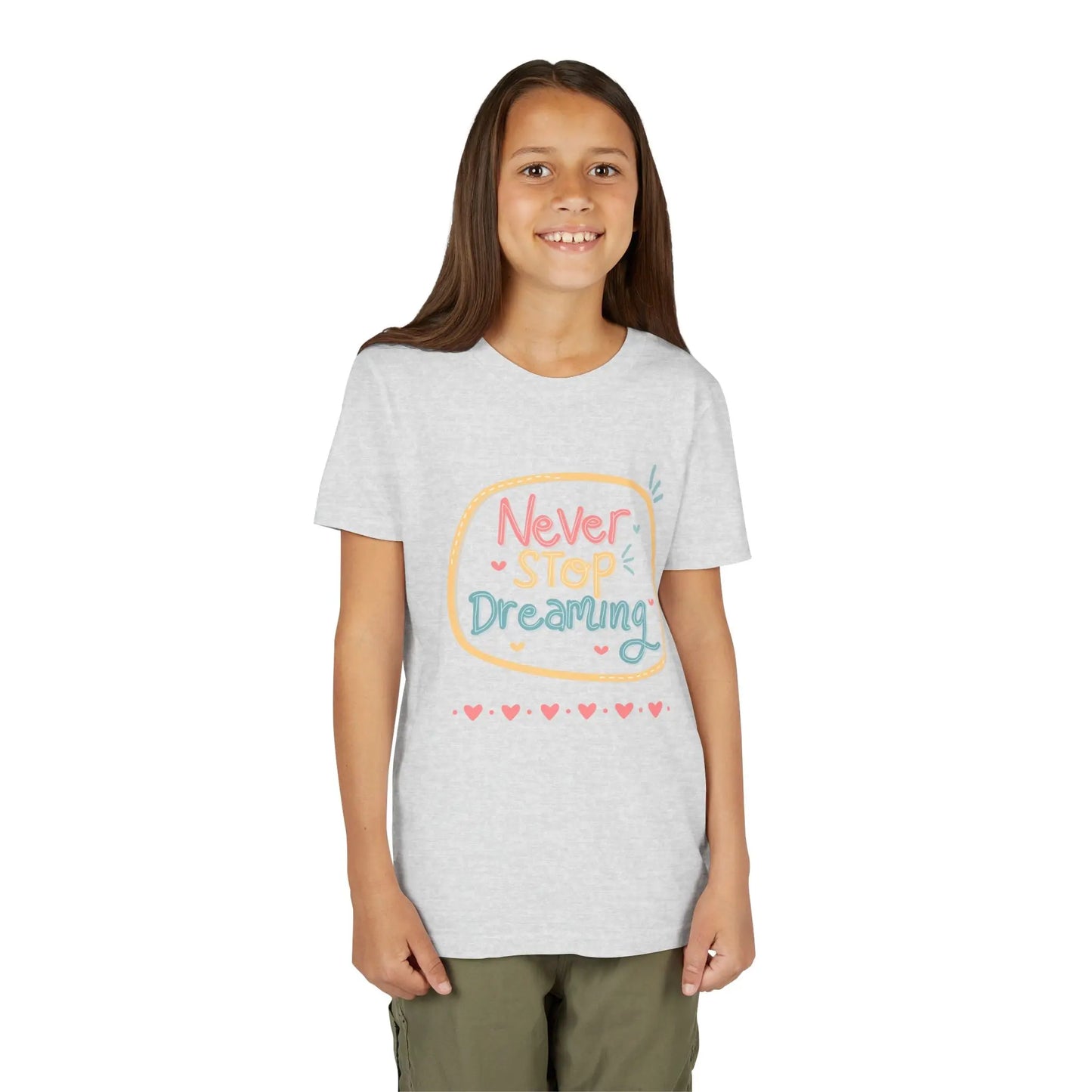 Youth wearing this encouraging youth tee with "Never Stop Dreaming" message. Soft cotton, perfect for school, everyday wear, and inspiring creativity. Motivational kids' clothing. Ash