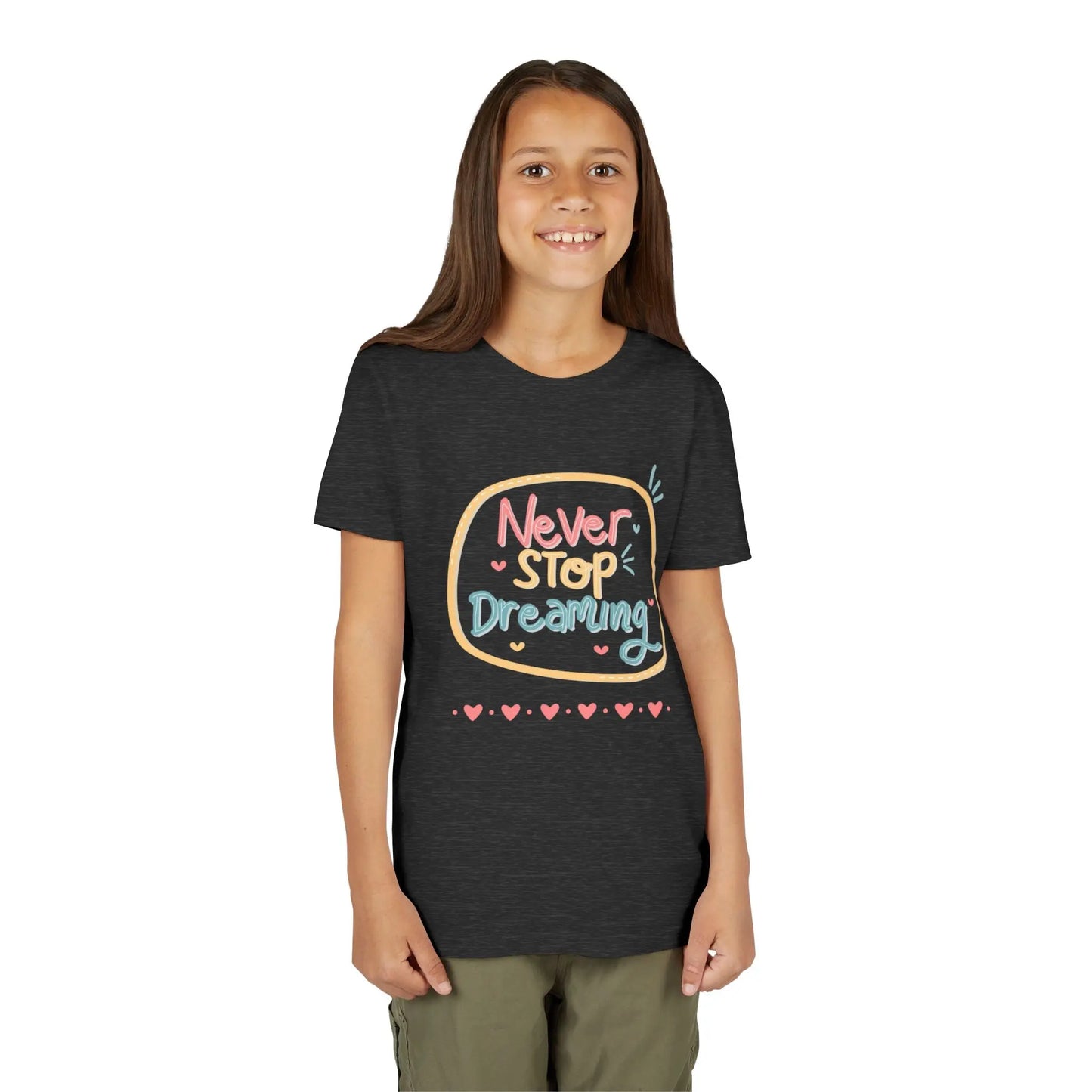 Youth wearing this encouraging youth tee with "Never Stop Dreaming" message. Soft cotton, perfect for school, everyday wear, and inspiring creativity. Motivational kids' clothing. Dark Grey Heather 