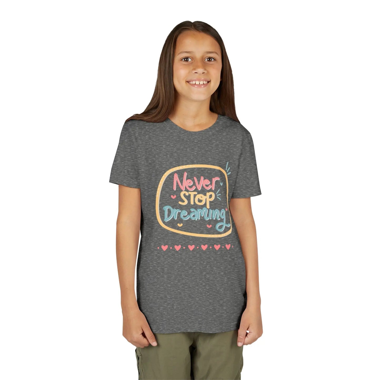 Youth wearing this encouraging youth tee with "Never Stop Dreaming" message. Soft cotton, perfect for school, everyday wear, and inspiring creativity. Motivational kids' clothing. Deep Heather