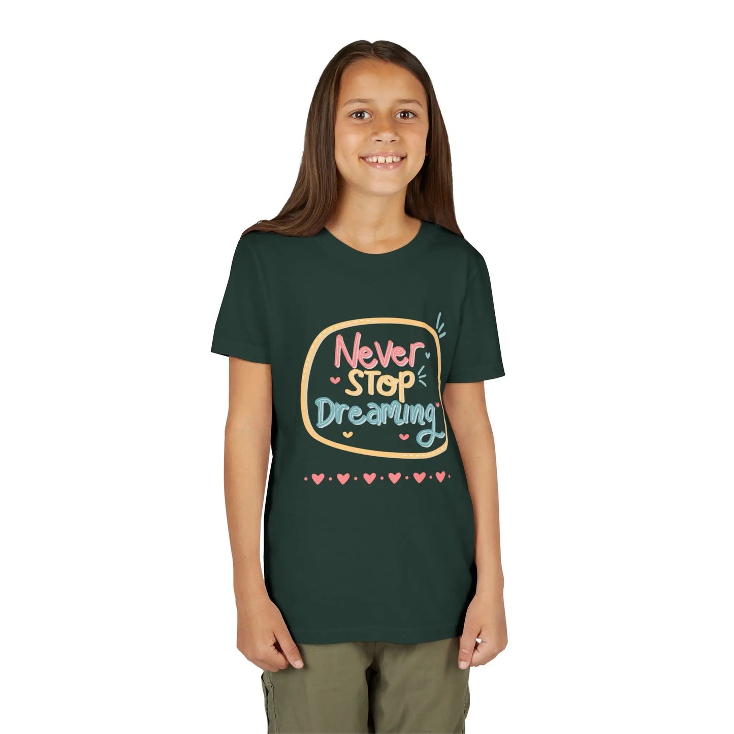 Youth wearing this encouraging youth tee with "Never Stop Dreaming" message. Soft cotton, perfect for school, everyday wear, and inspiring creativity. Motivational kids' clothing. Forest